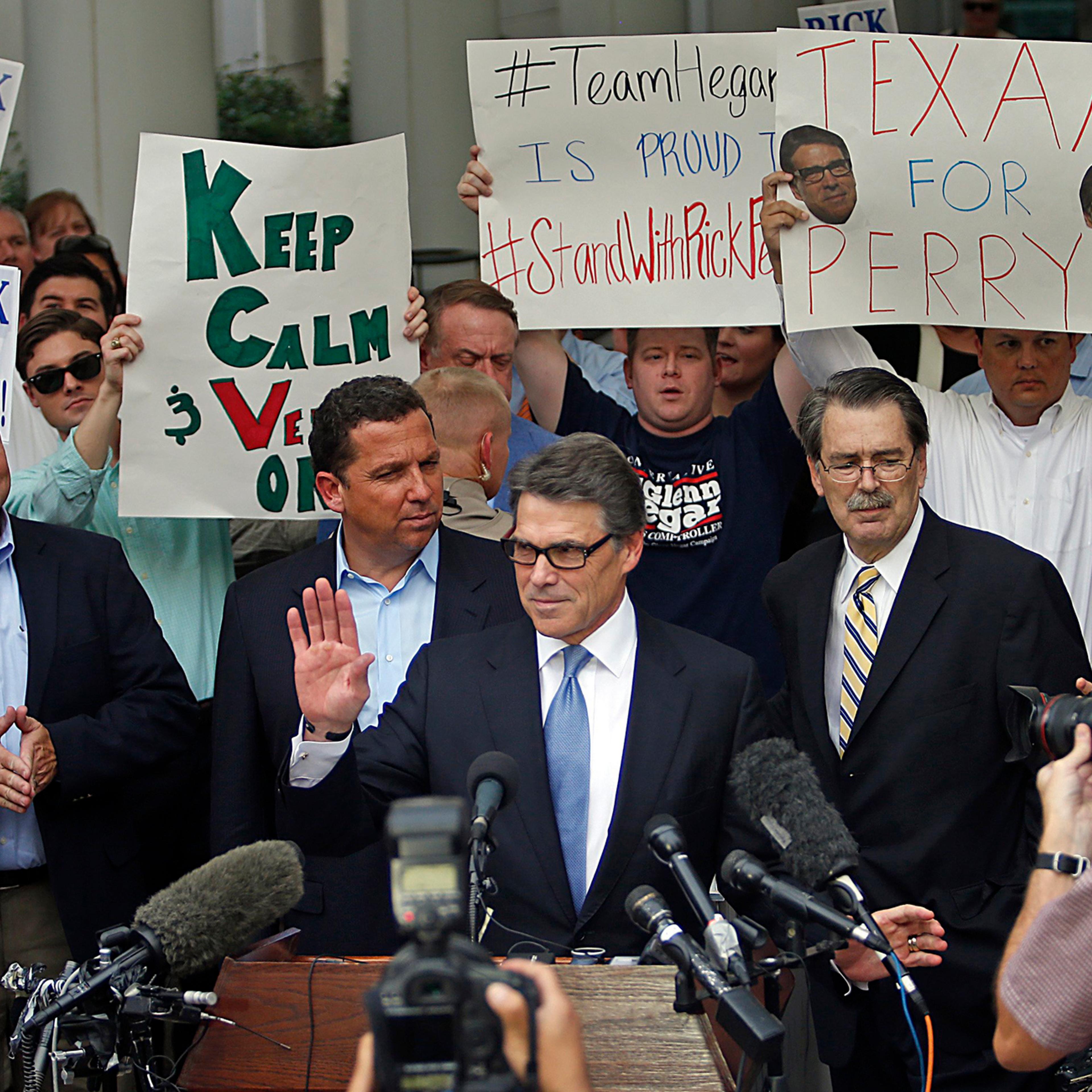 Texas Governor Rick Perry acknowledges the crowd after being finger printed at the Blackwell-Thurman Criminal Justice Center on Aug. 19, 2014 in Austin.