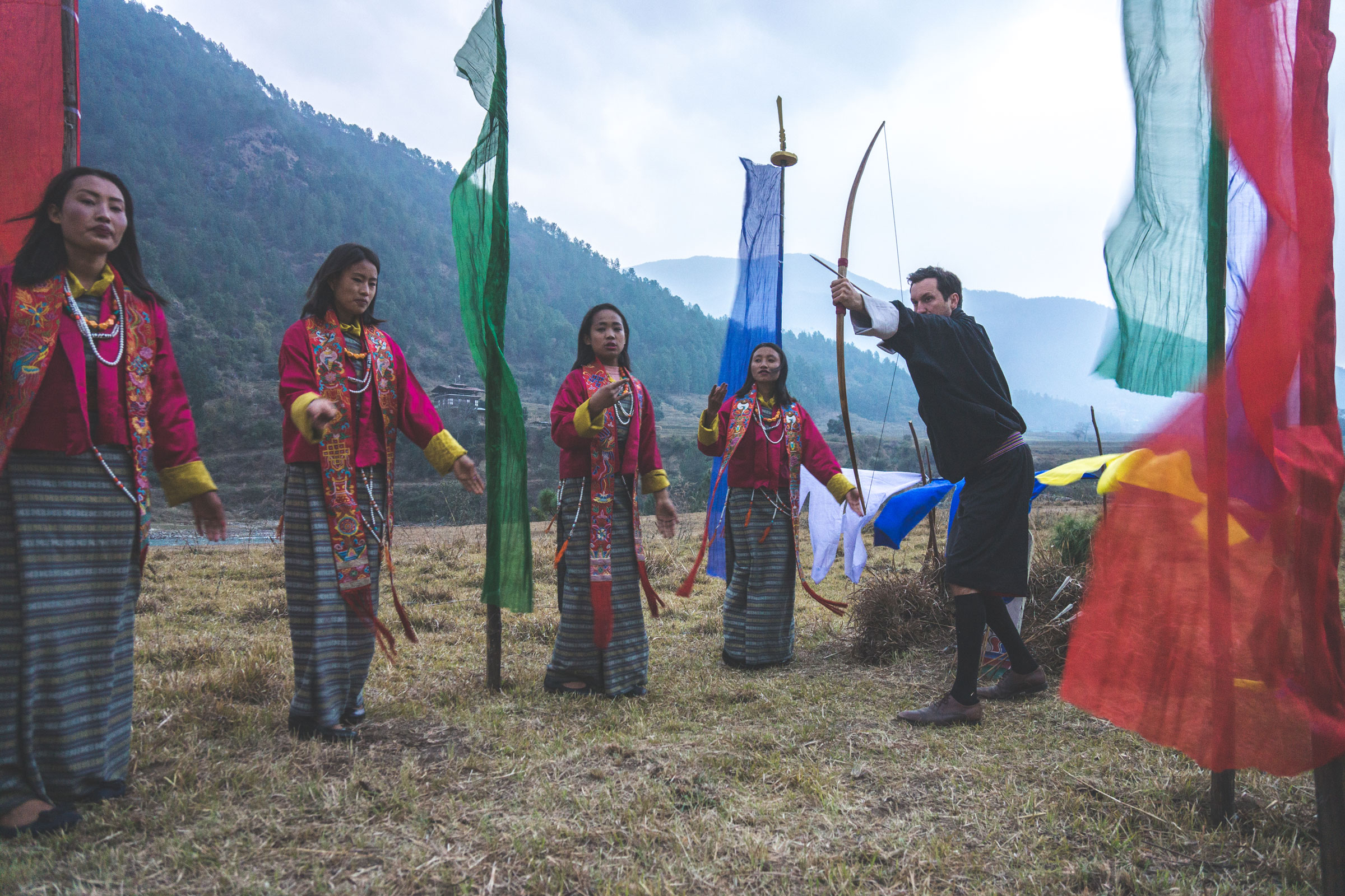 A man holds a bow and arrow at Sangwa Camp