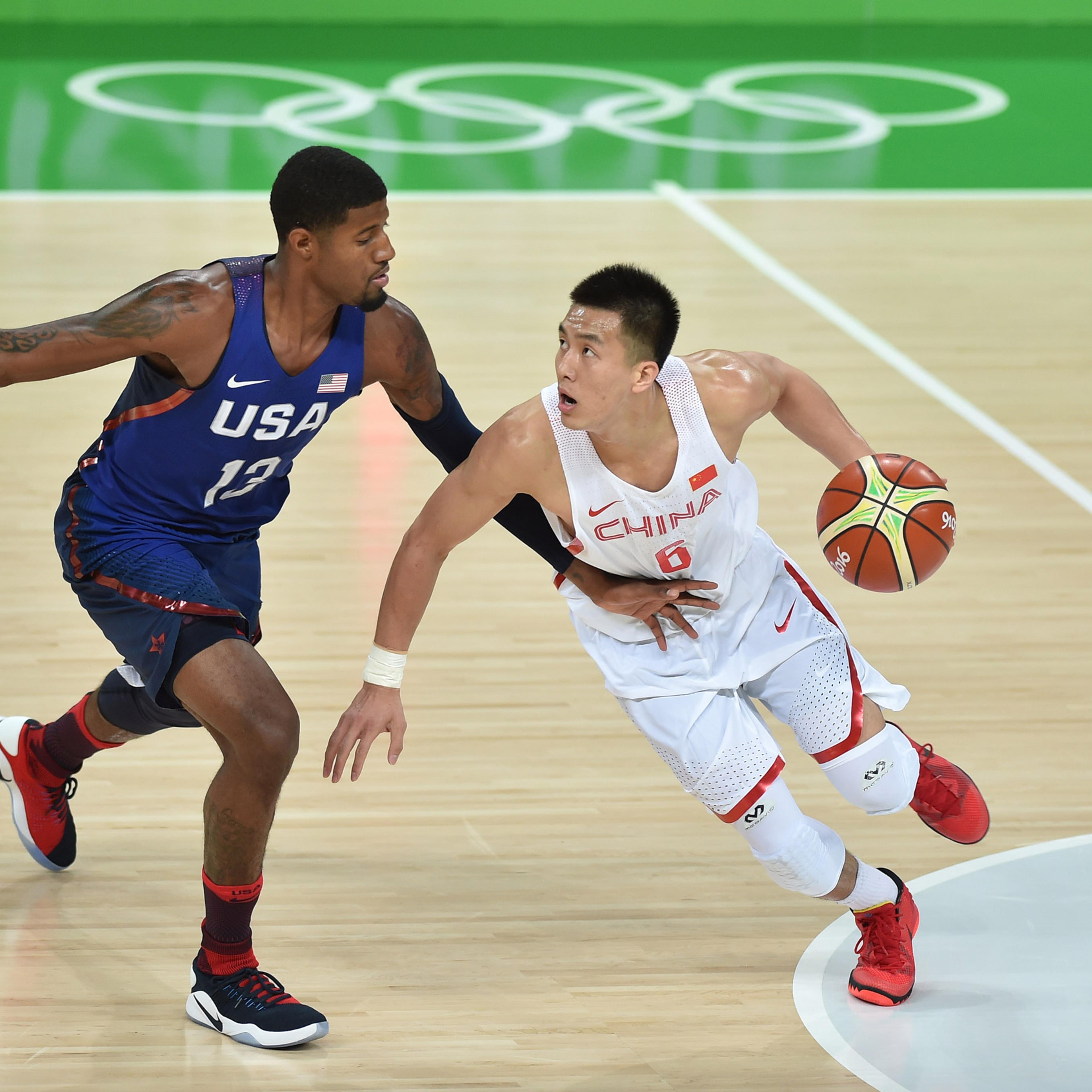Paul George and Ailun Guo in action during the China vs USA basketball game at the 2016 Rio Olympic Games on Aug. 6, 2016.