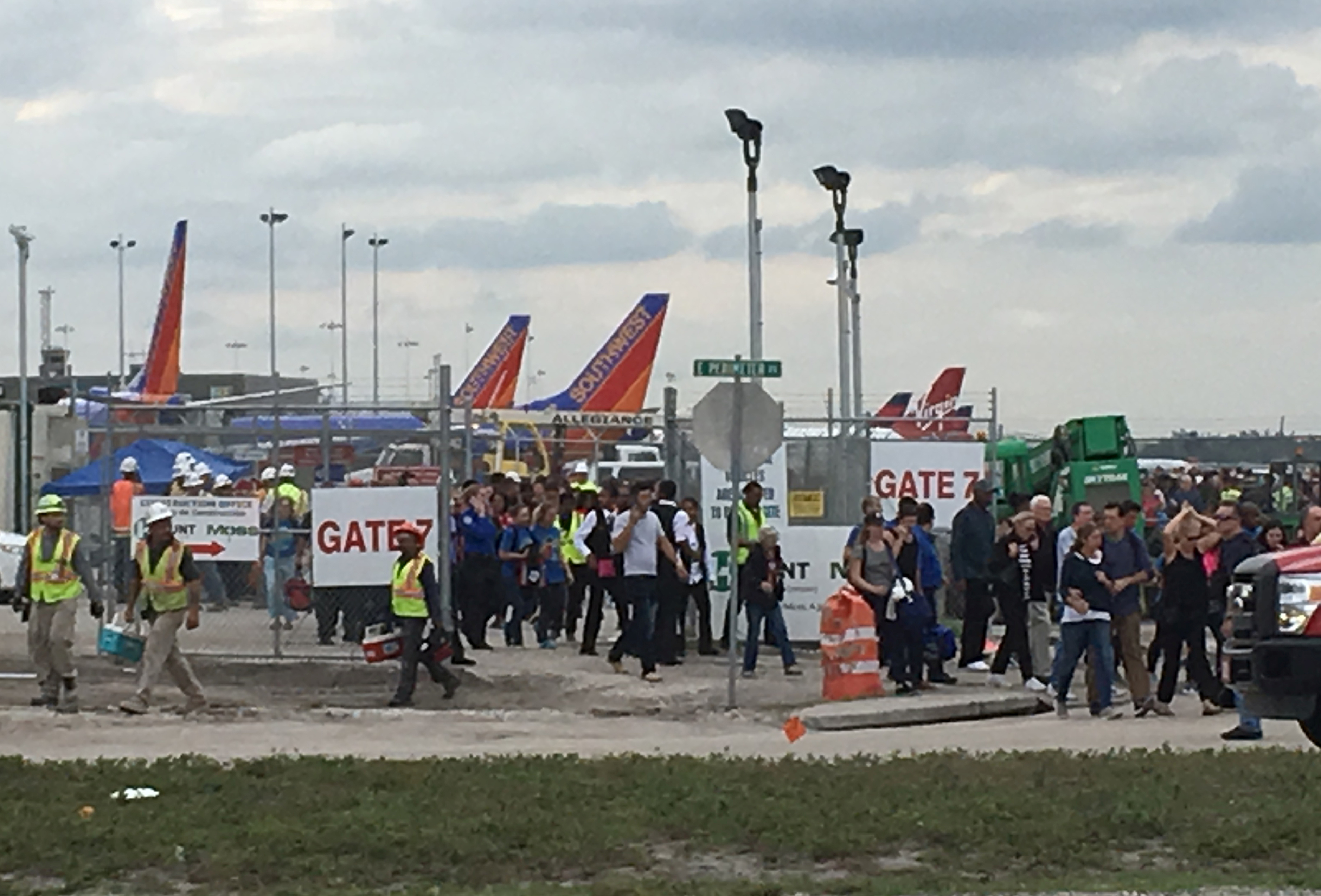 Travelers and airport workers are evacuated out of the terminal after airport shooting at Fort Lauderdale-Hollywood International Airport in Florida, Jan. 6, 2017.