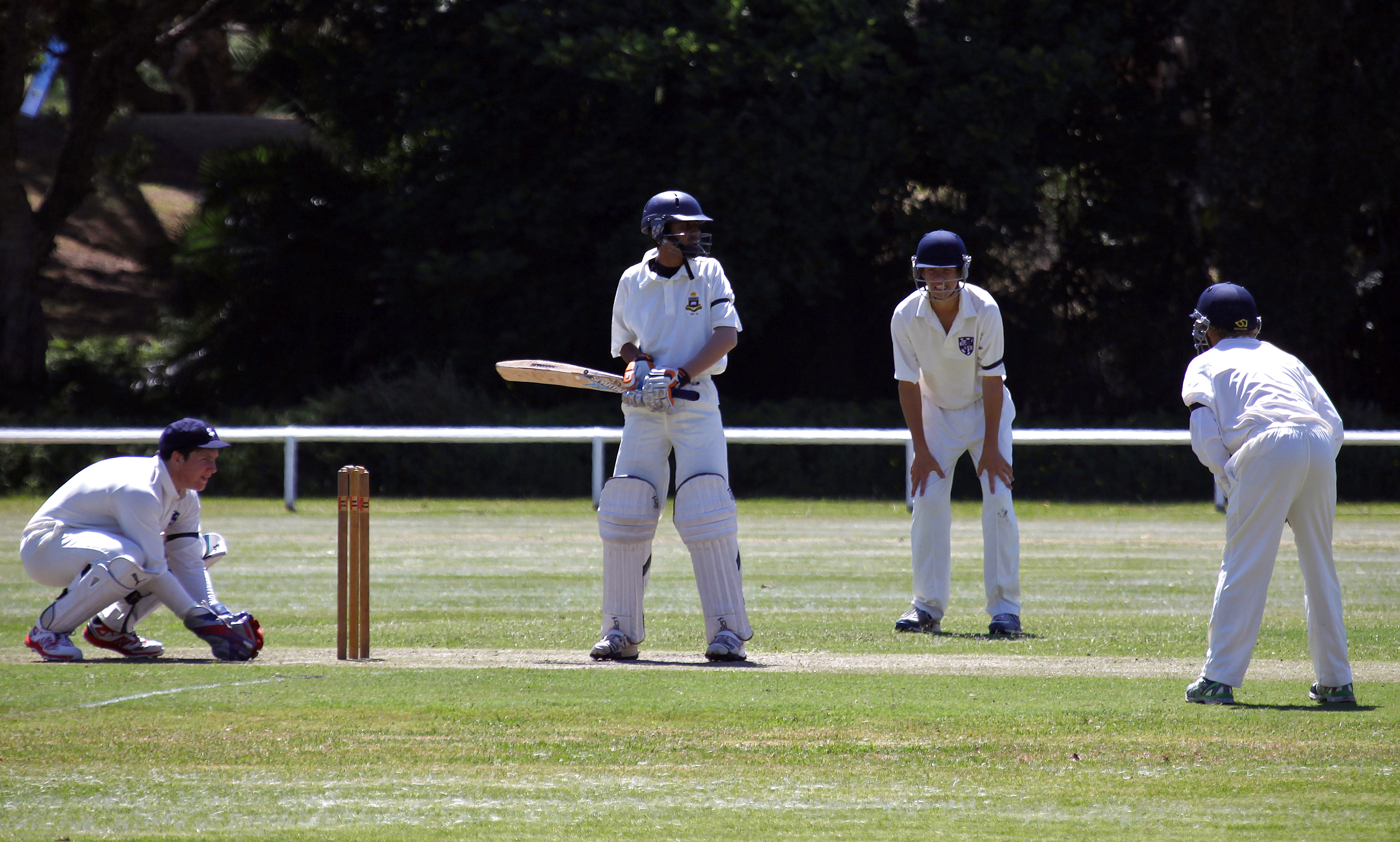 Young cricketers wear black armbands as a tribute to Australian cricketer Phillip Hughes, who died on Thursday, during a schoolboy's cricket match at Centennial Park in Sydney