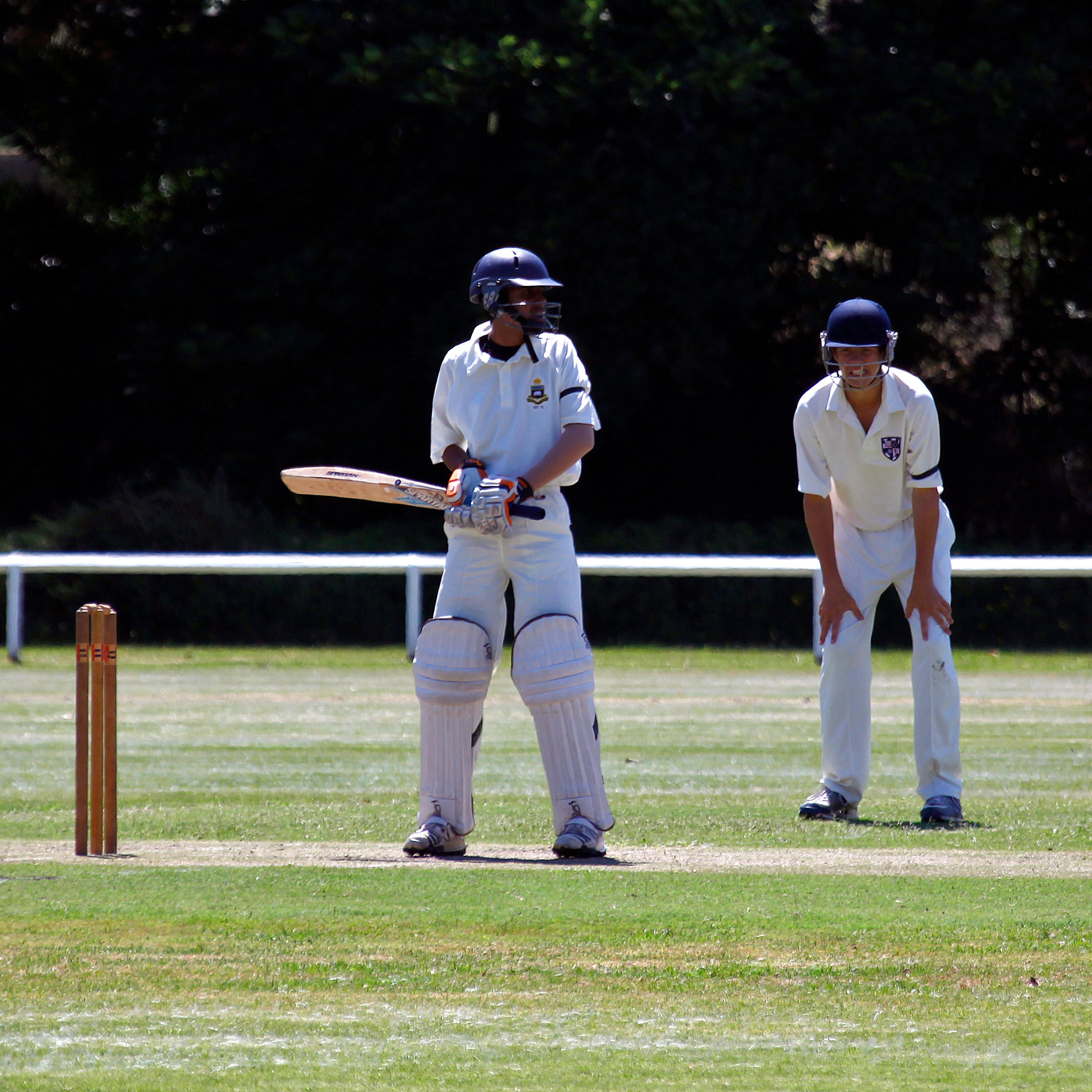 Young cricketers wear black armbands as a tribute to Australian cricketer Phillip Hughes, who died on Thursday, during a schoolboy's cricket match at Centennial Park in Sydney