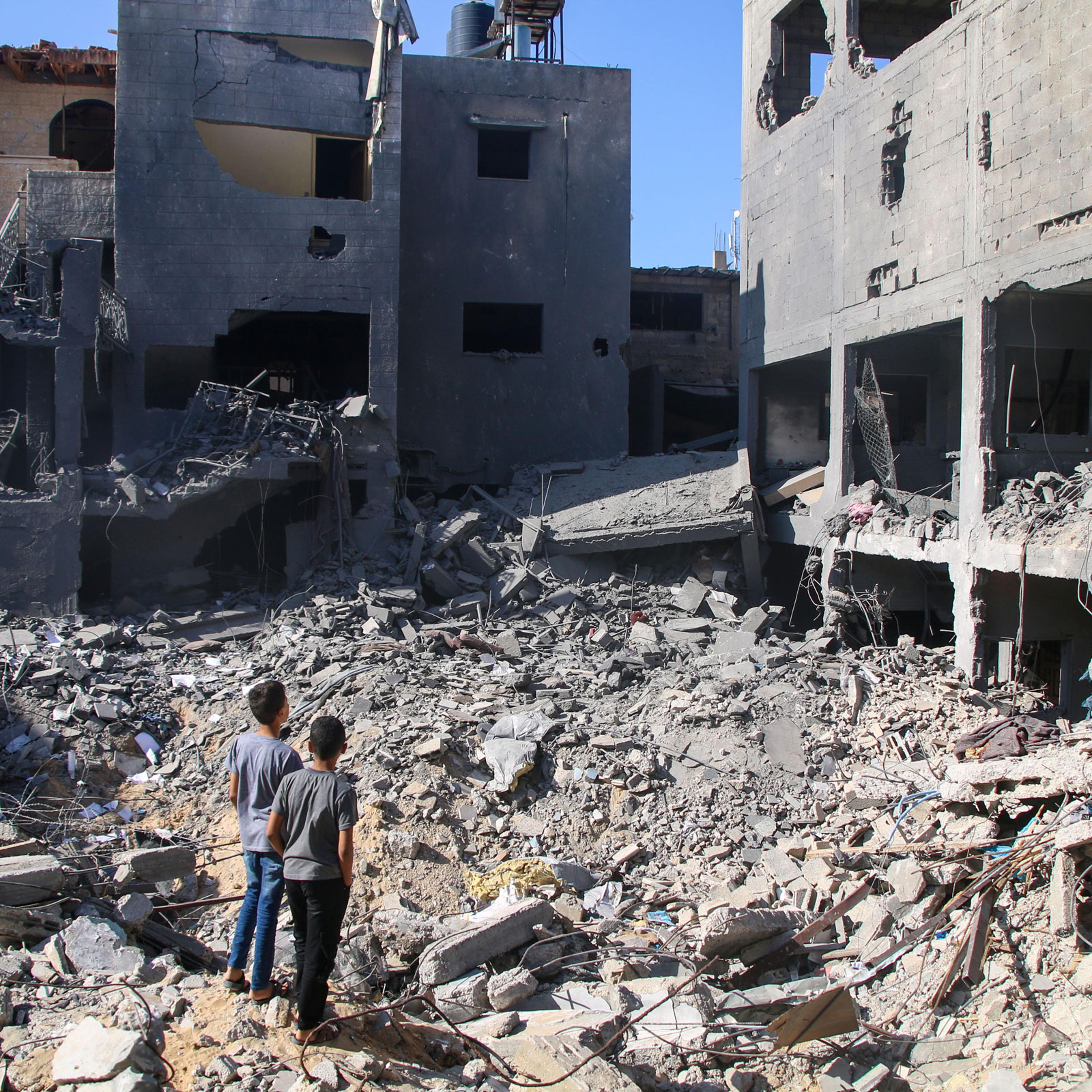 Local citizens search for victims in buildings destroyed during Israeli air raids