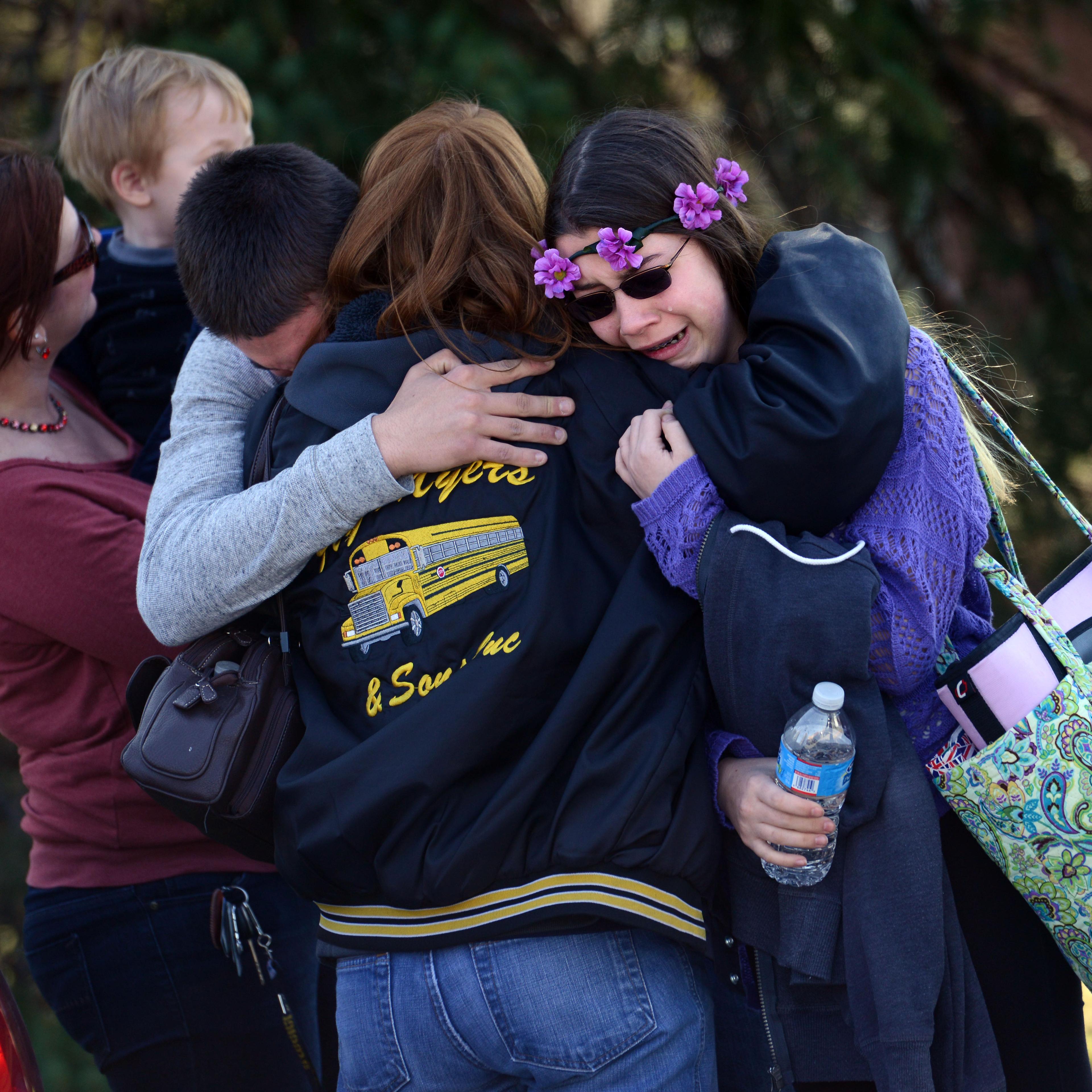 Parents and students embrace near Franklin Regional High School after more than a dozen students were stabbed by a knife wielding suspect at the school in Murrysville, Pa., April 9, 2014.
