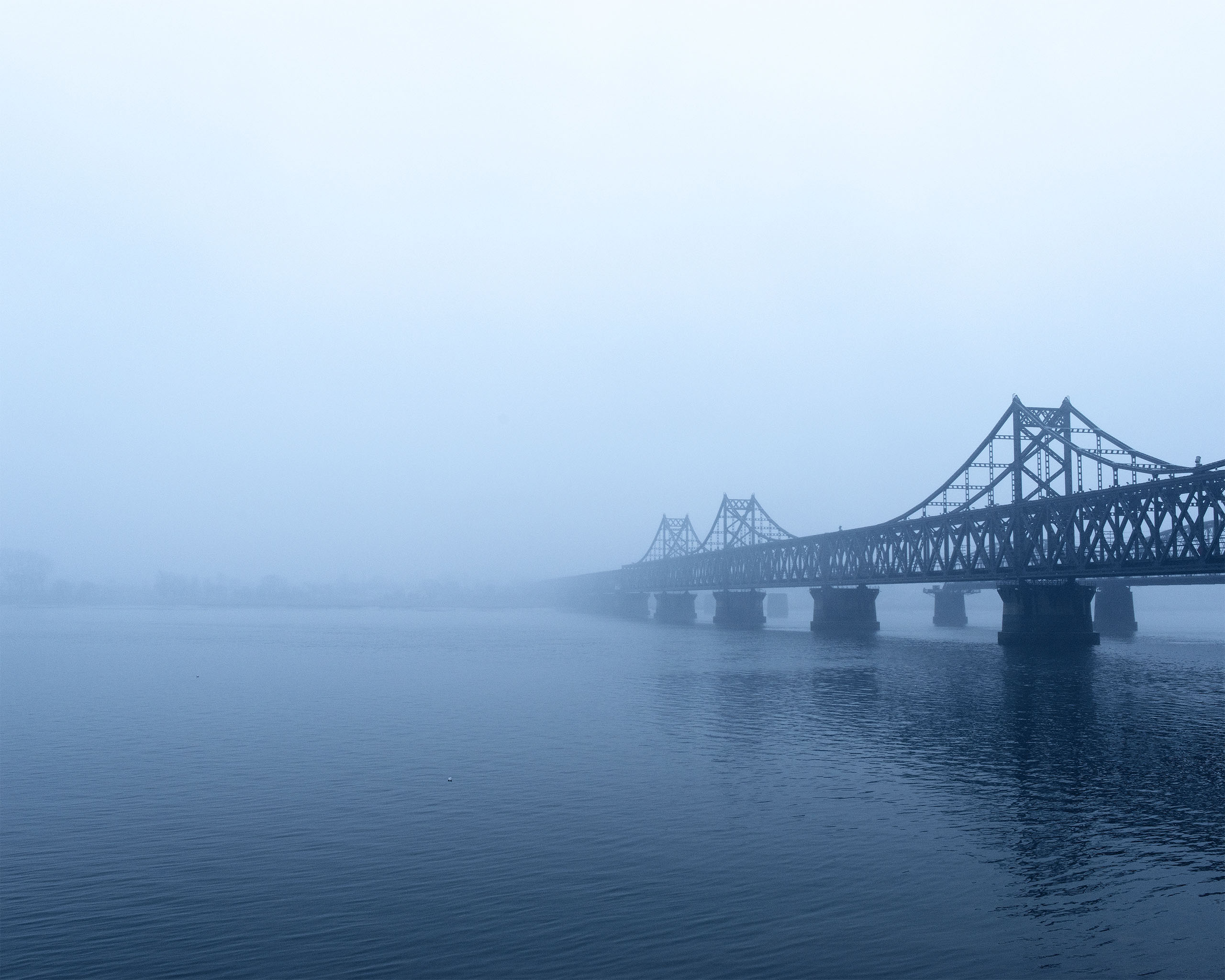 The Sino-Korean Friendship Bridge spans the Yalu River, connecting the cities of Dandong, China, and Sinuiju, North Korea.