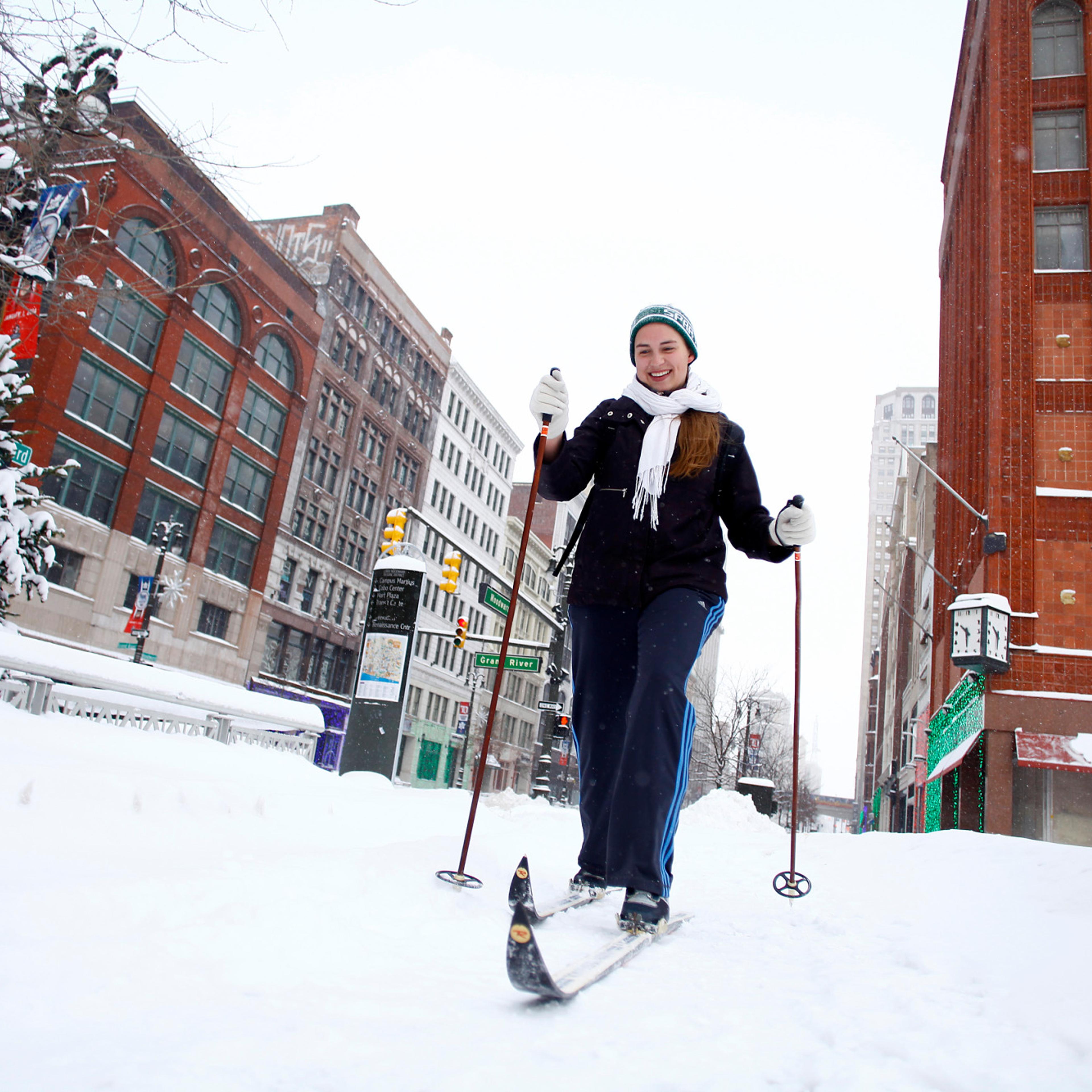 Alison Mueller skies to work through several inches of snow along Woodward Avenue as the area deals with record breaking freezing weather January 6, 2014 in Detroit, Michigan