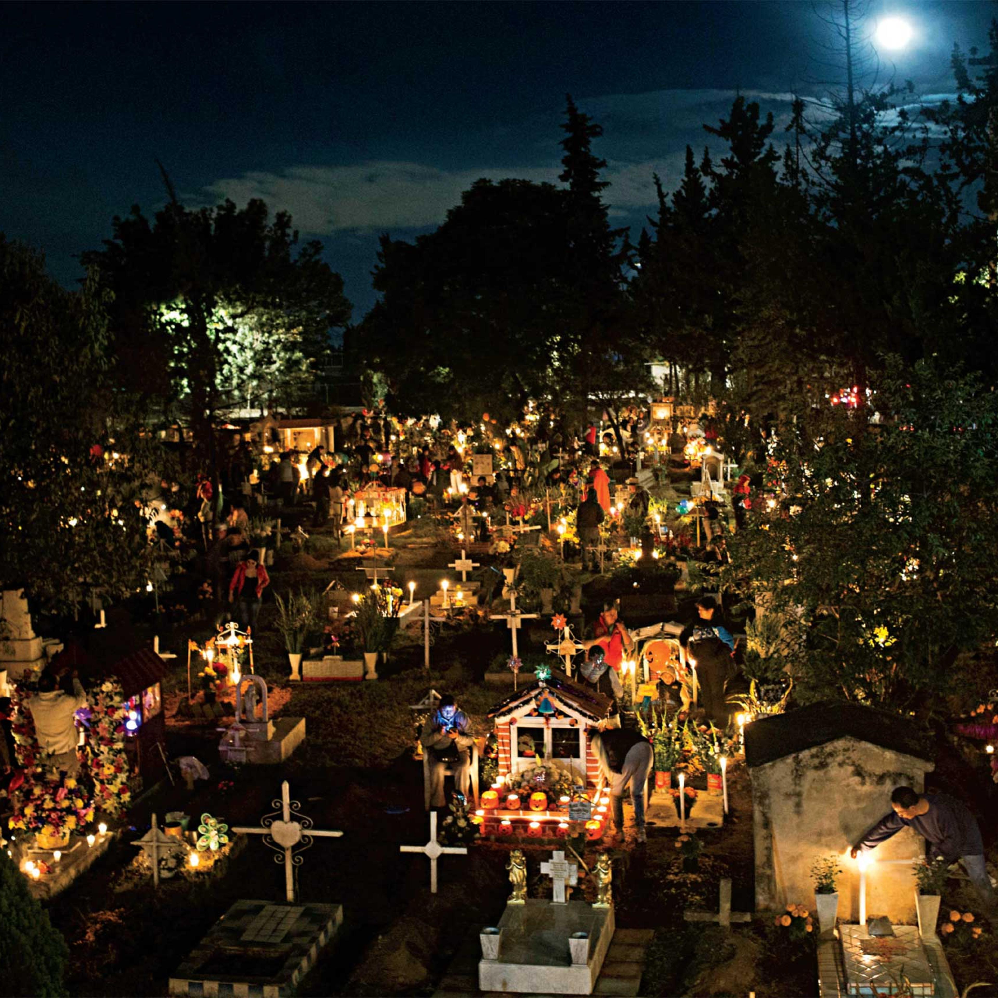 <b>Photograph by Esteban Felix—AP</b><br>Mexicans mark Día de los Muertos (Day of the Dead) on Nov. 1 at the San Gregorio cemetery in Mexico City, placing candles and marigolds on children's tombs to honor the deceased. Adults' graves would get the same treatment the following night. (TIME issue November 16, 2015)
