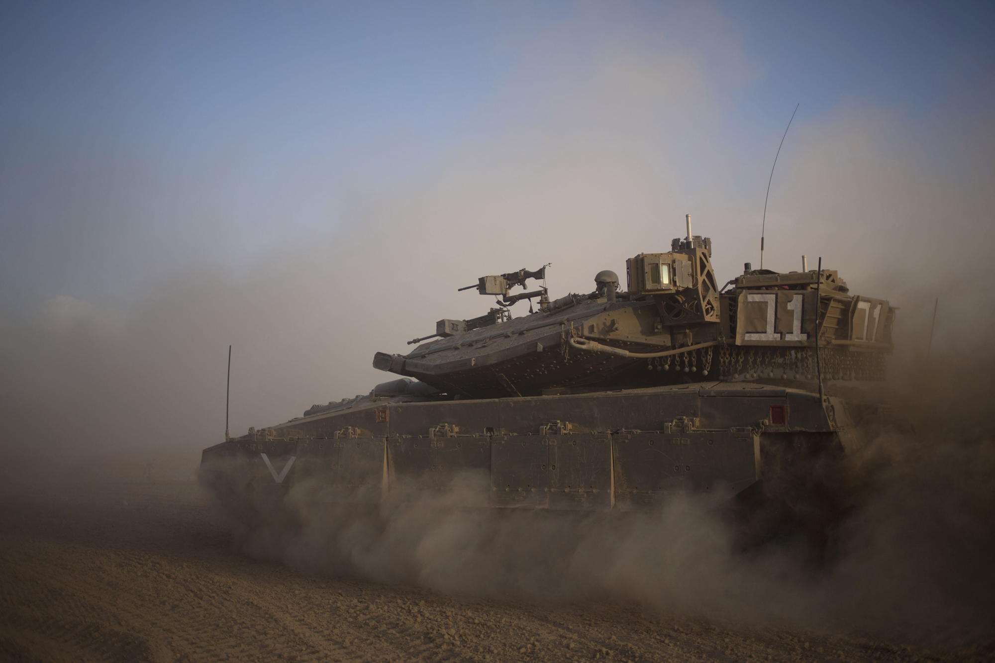 An Israeli tank maneuvers to take a position along the Israel-Gaza Border, July 17, 2014.