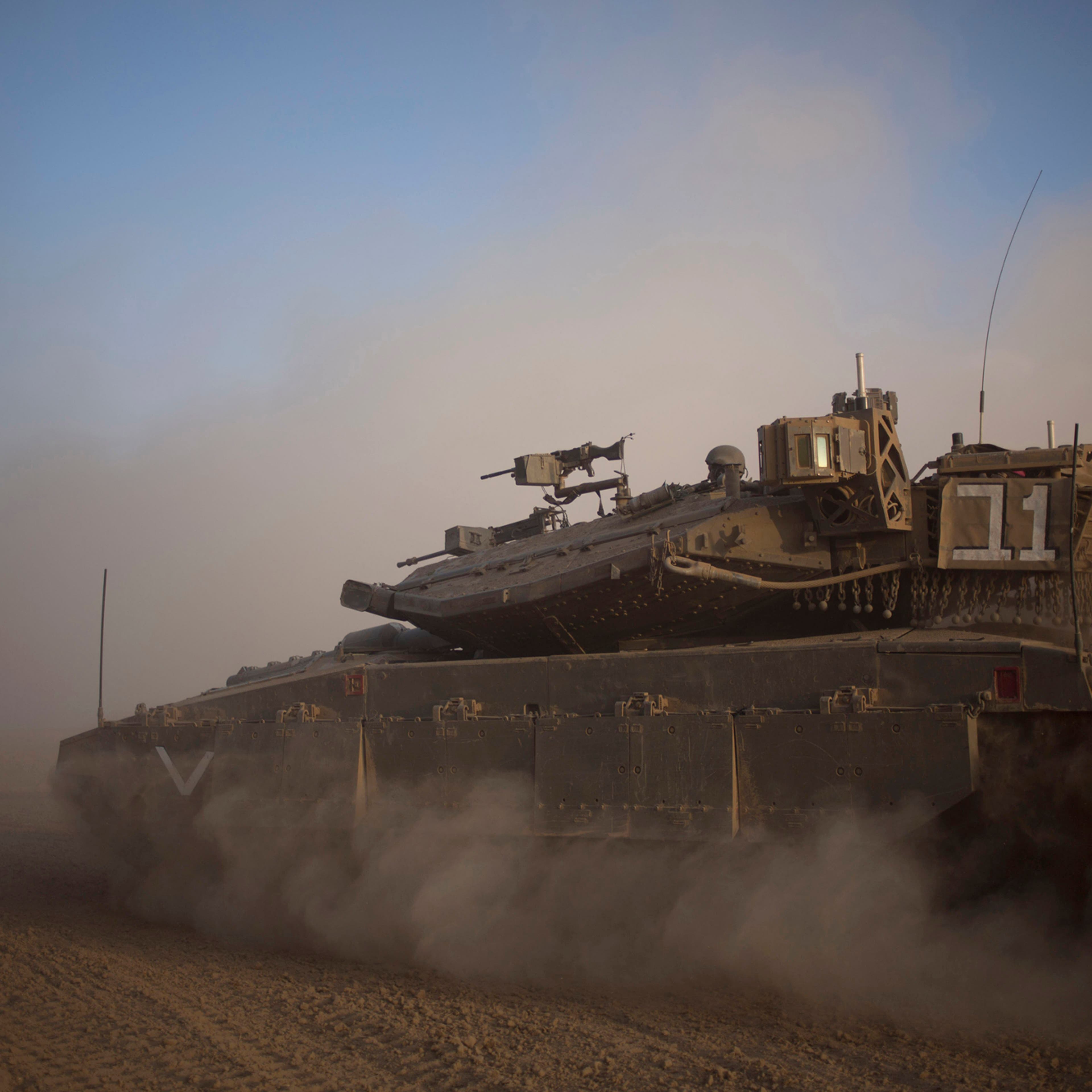 An Israeli tank maneuvers to take a position along the Israel-Gaza Border, July 17, 2014.