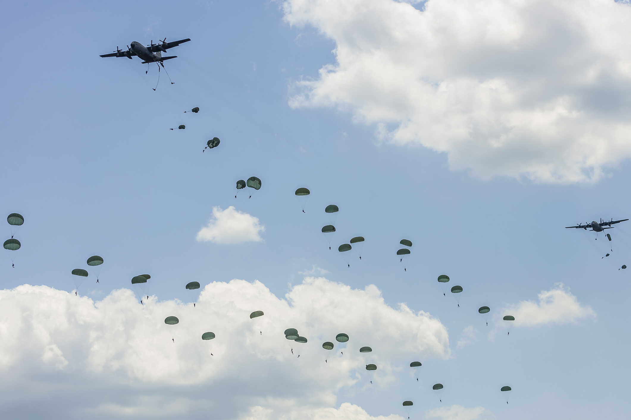 At least 22 soldiers were injured in a night time military exercise at a Mississippi military base after parachuting from a C-130 plane. Pictured are airborne troops over Andrews Air Force Base, Maryland after parachuting from a U.S. Air Force C-130 Herc