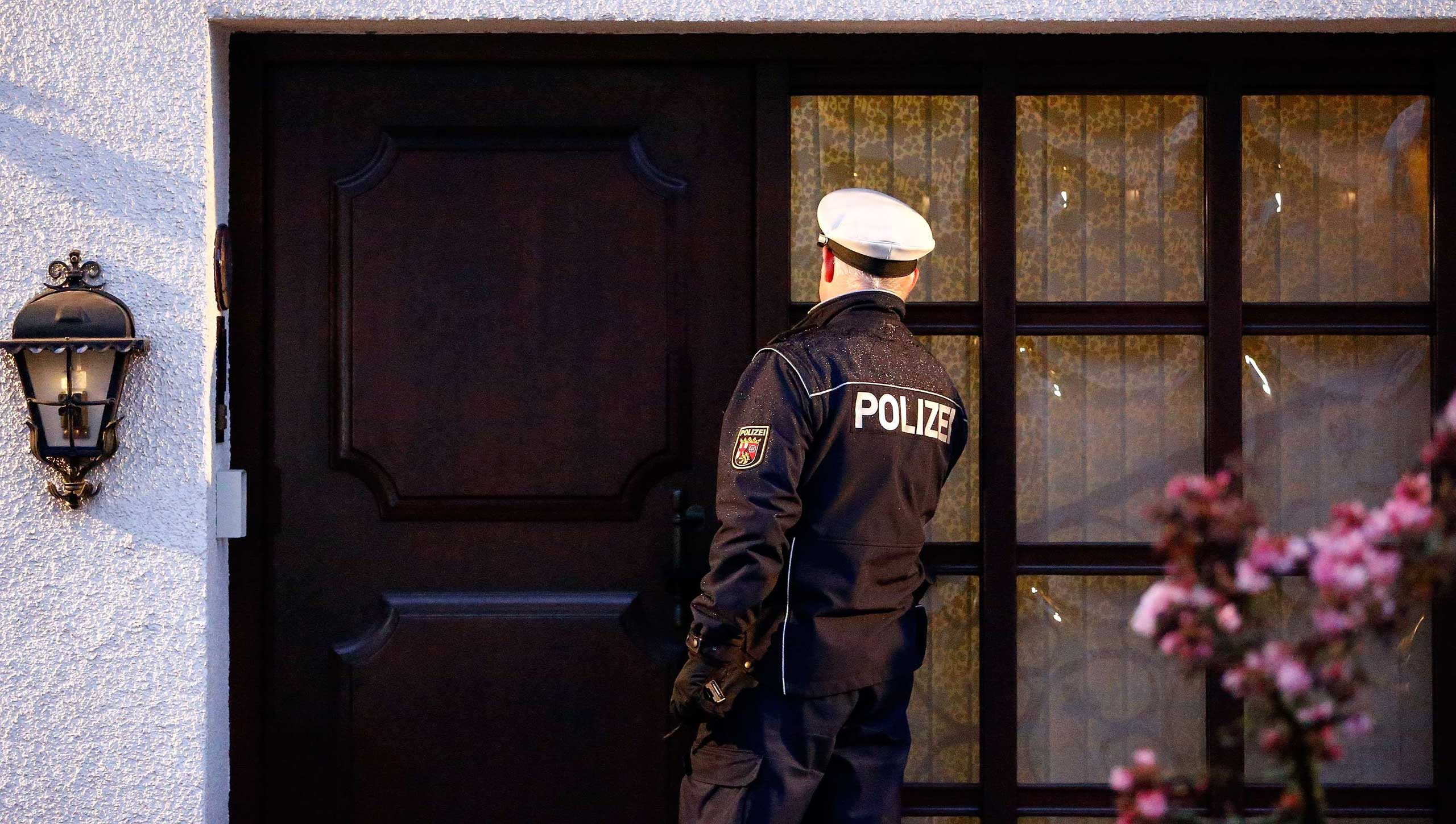 A German police officer enters the house believed to belong to crashed Germanwings flight 4U 9524 co-pilot Andreas Lubitz in Montabaur, Germany on March 26, 2015.