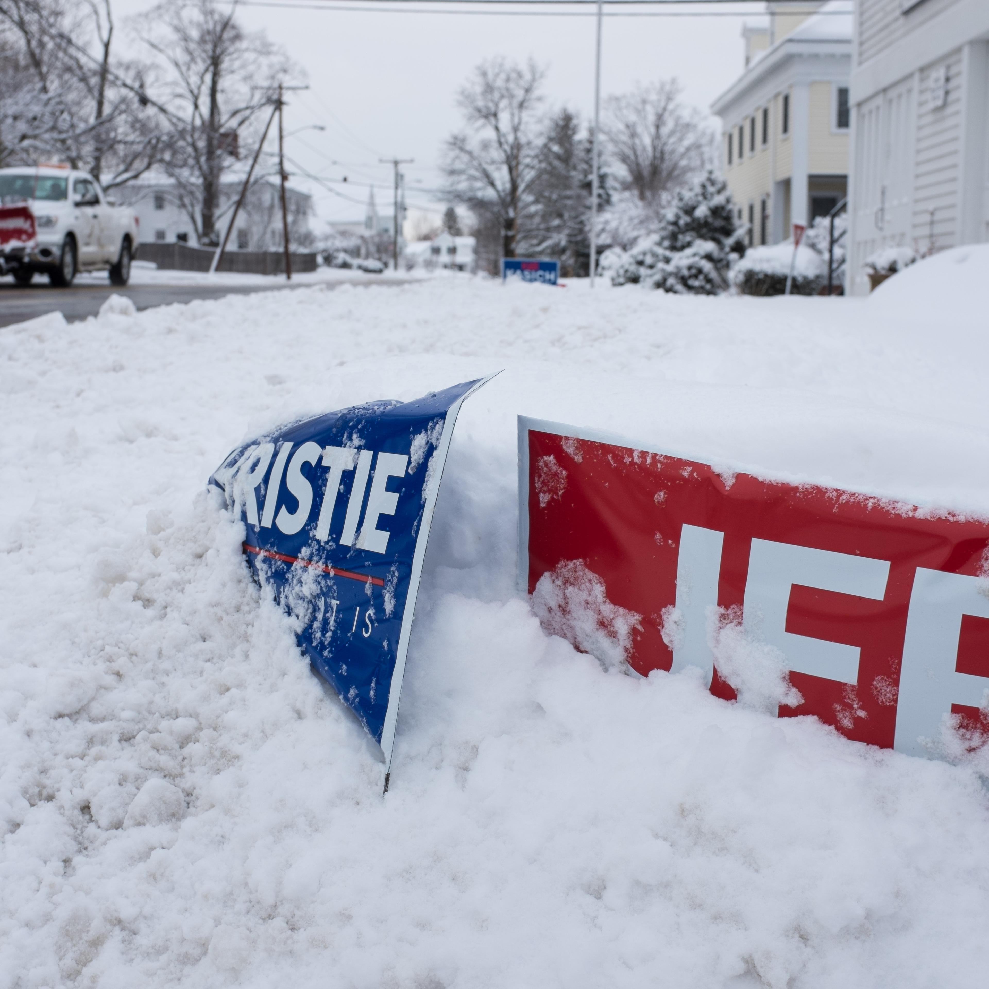 Political signs buried in snow are seen on Feb. 5, 2016 in Hollis, New Hampshire.