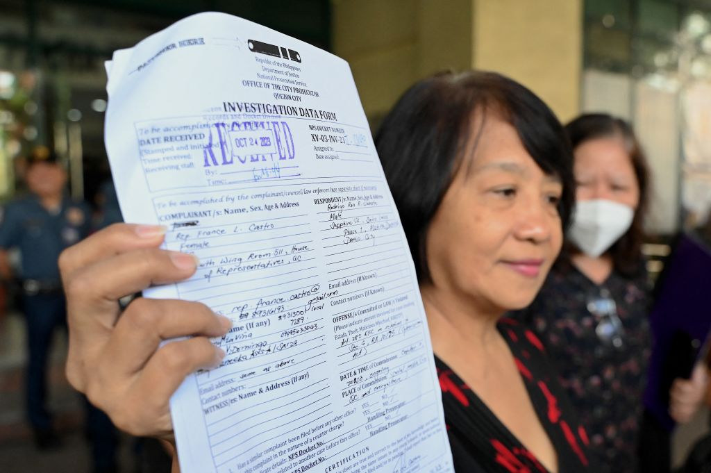 Philippine legislator France Castro shows a document after filing a criminal complaint against former Philippine President Rodrigo Duterte, at the Office of the Prosecutor in Quezon City on Oct. 24, 2023, following the malicious threats made by Duterte i