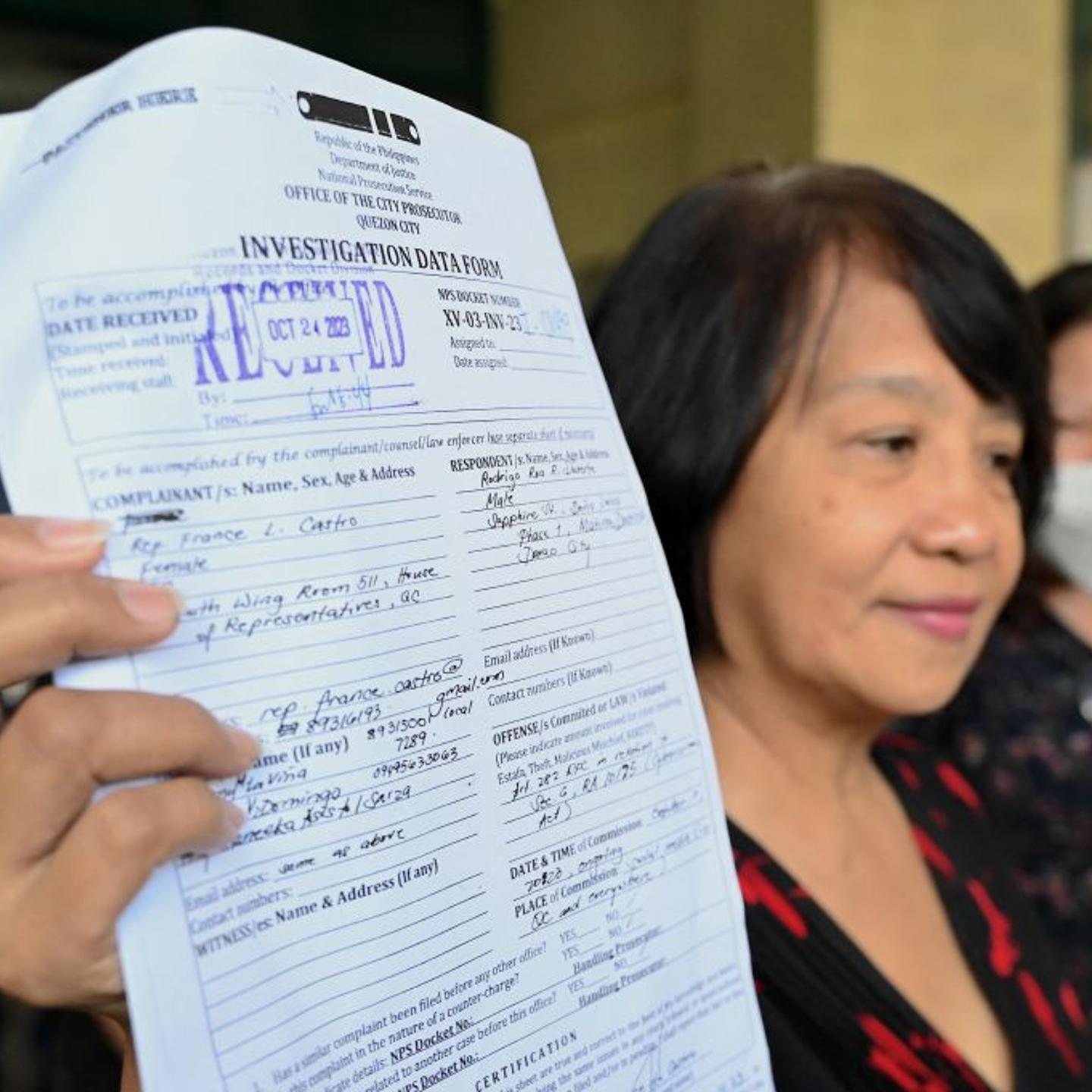 Philippine legislator France Castro shows a document after filing a criminal complaint against former Philippine President Rodrigo Duterte, at the Office of the Prosecutor in Quezon City on Oct. 24, 2023, following the malicious threats made by Duterte i