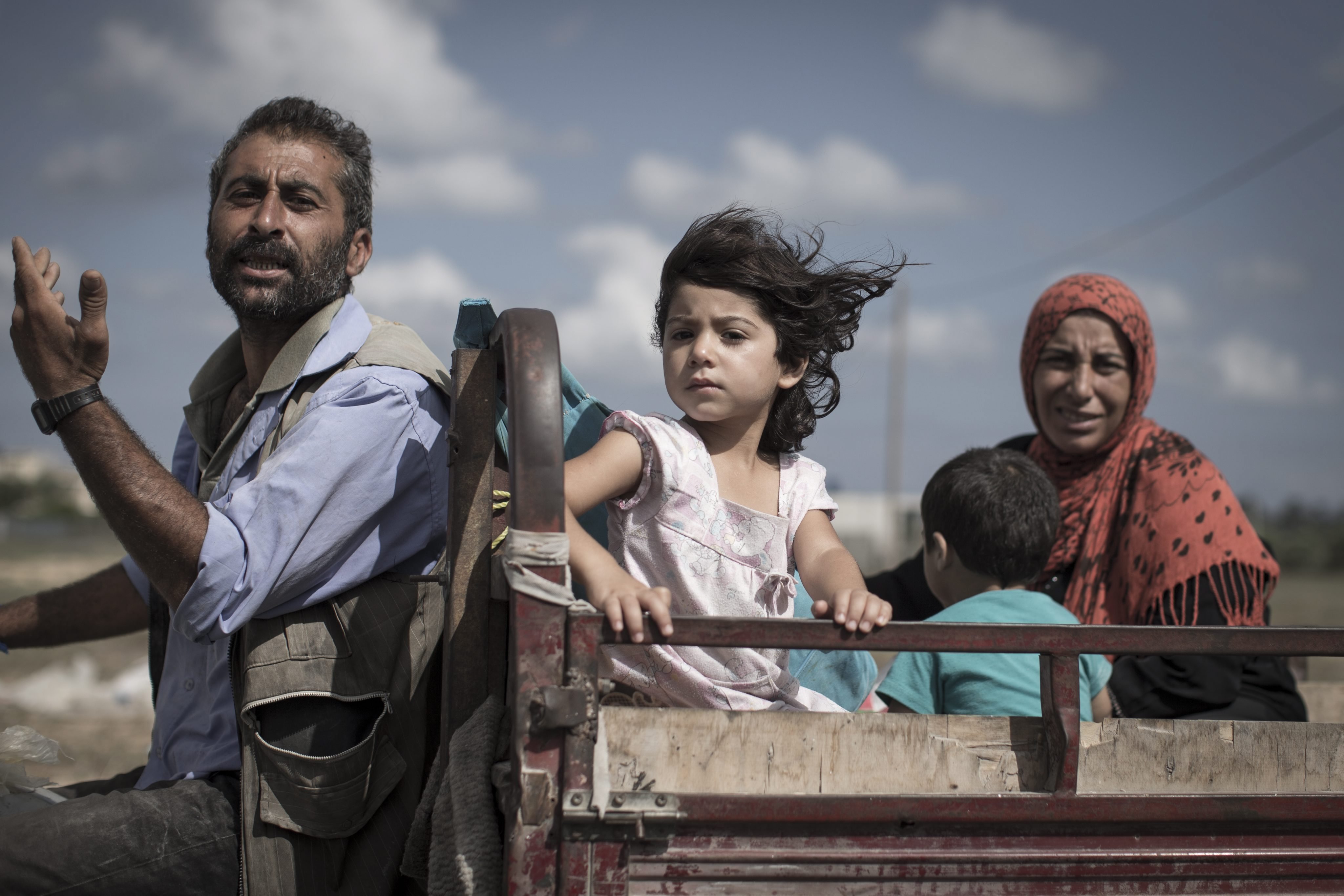 A Palestinian family who fled their homes is en route to seek shelter in a UN school in Khan Younis, Gaza Strip on July 18, 2014.