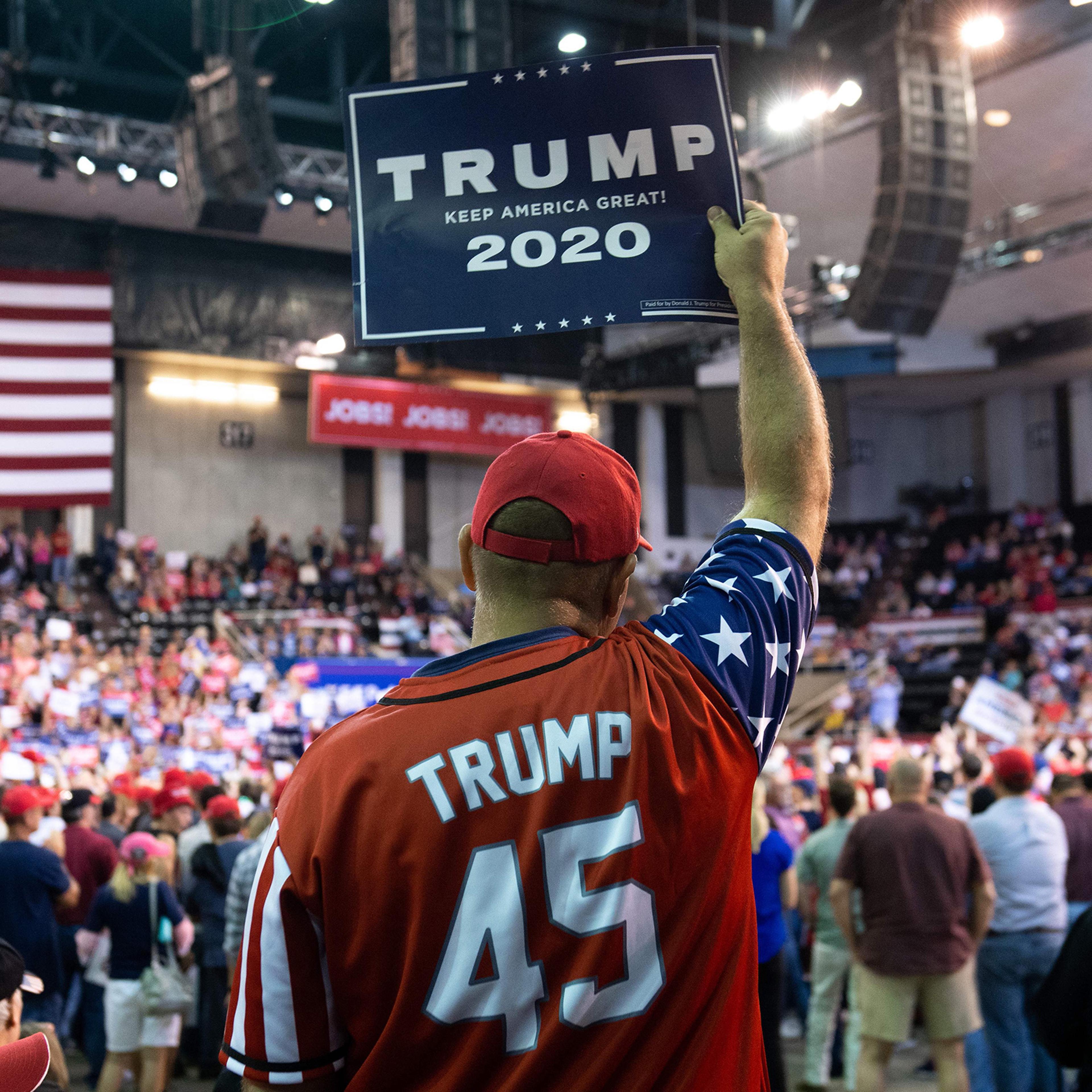A Trump supporter holds up a sign as the US president speaks during a "Keep America Great" rally at Sudduth Coliseum in Lake Charles, La. on Oct. 11, 2019