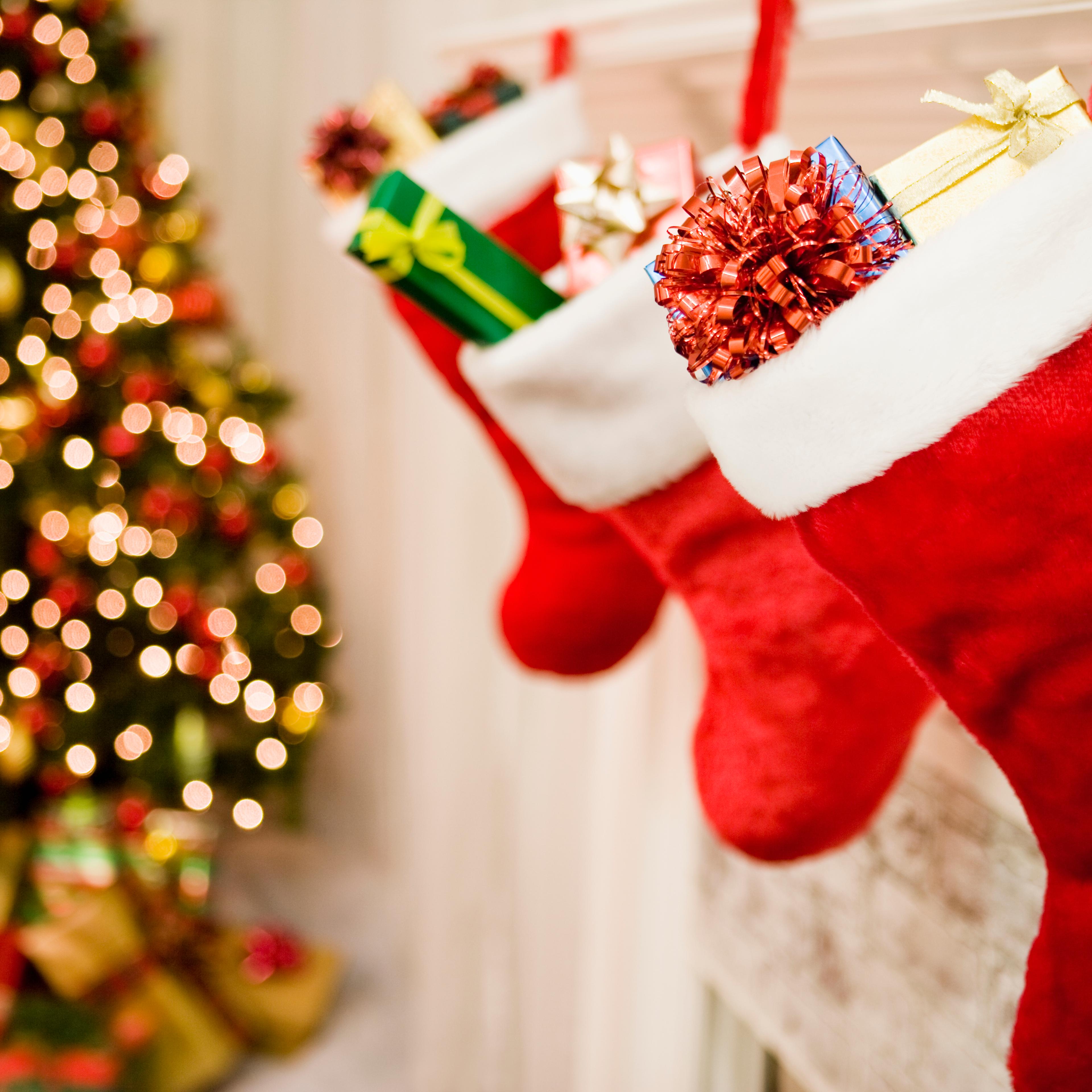 Christmas stockings hanging, Christmas tree in background, close-up