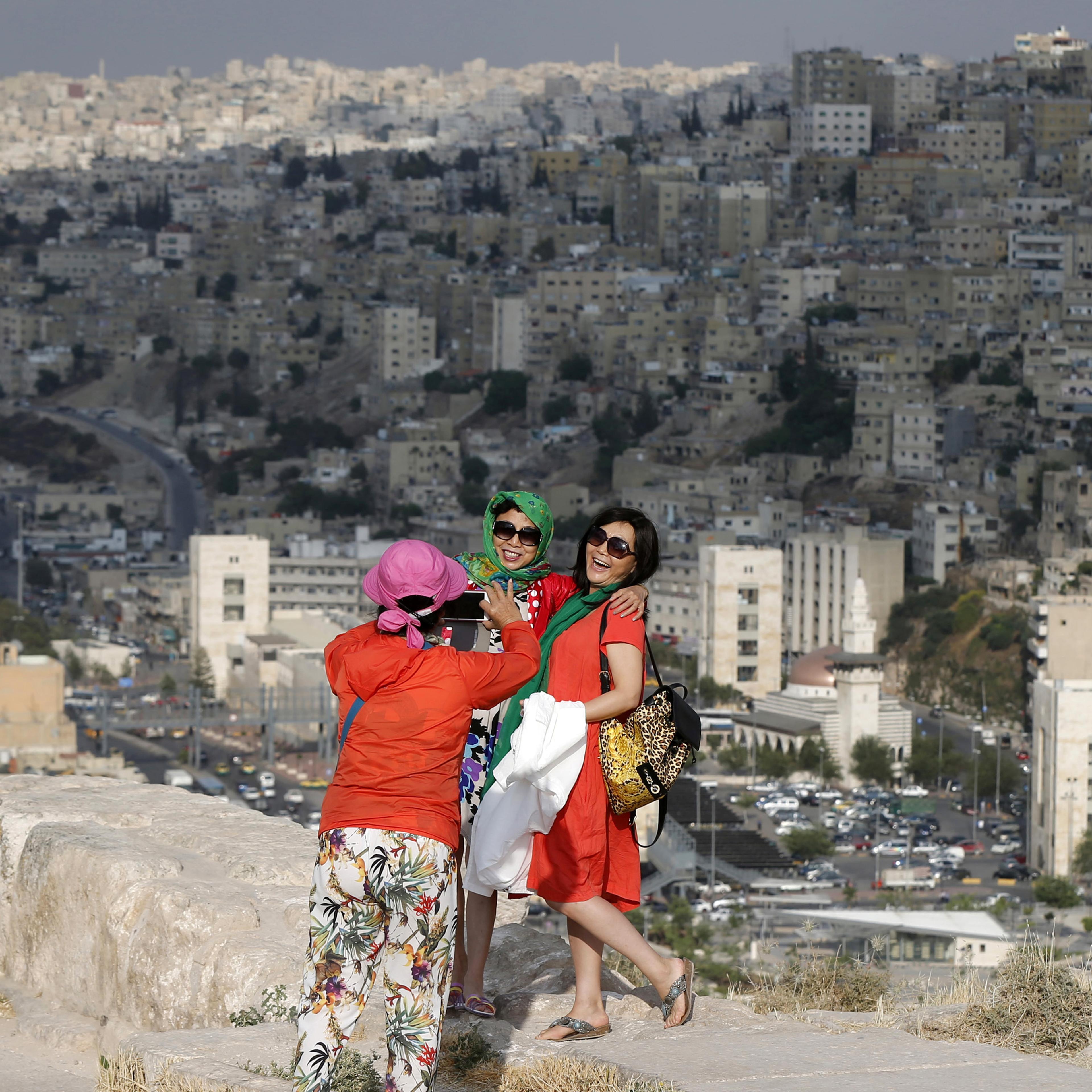 Chinese tourists take pictures during their visit to the Amman Citadel, an ancient Roman landmark in Amman