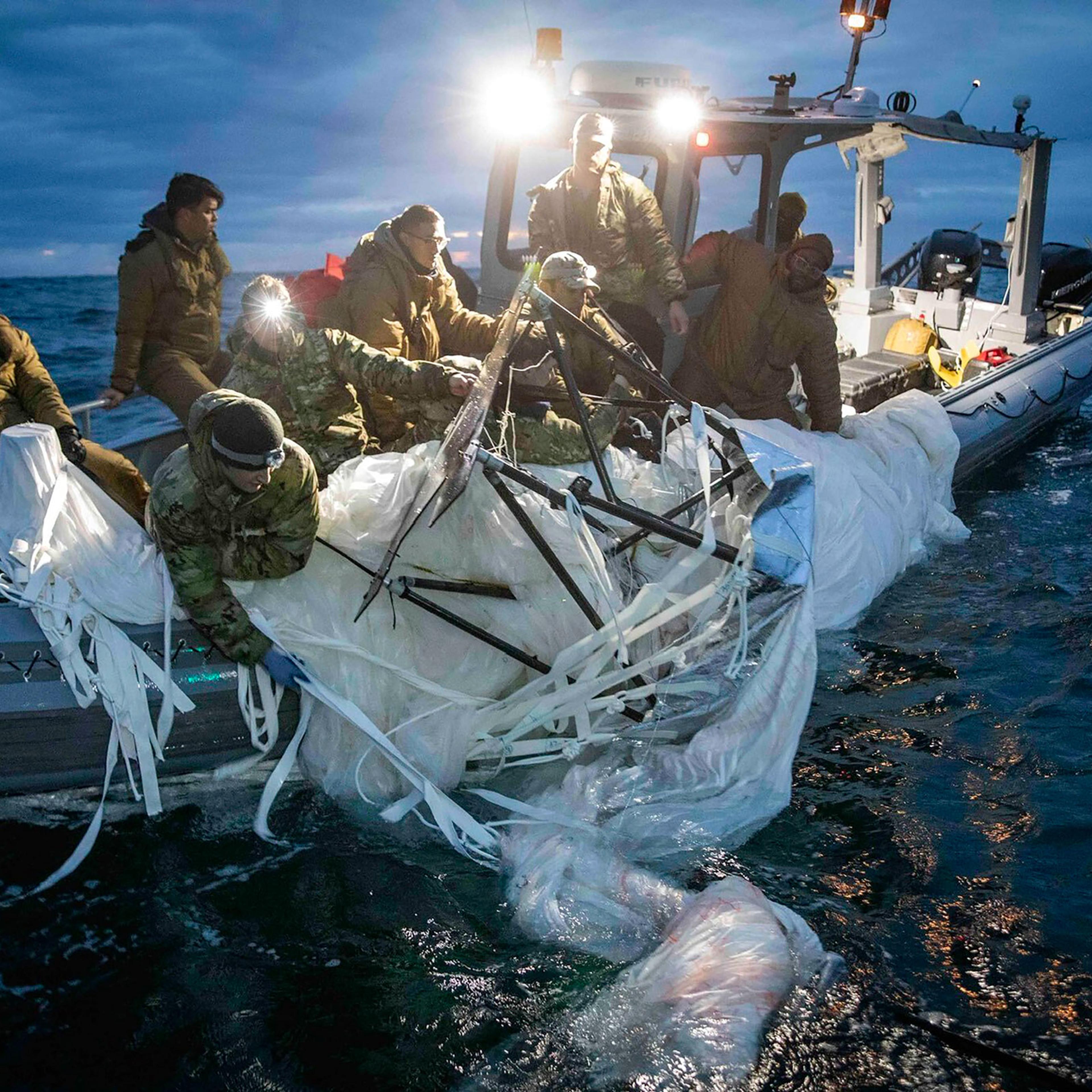 This image provided by the U.S. Navy shows sailors assigned to Explosive Ordnance Disposal Group 2 recovering a high-altitude surveillance balloon off the coast of Myrtle Beach, S.C., on Feb. 5, 2023.