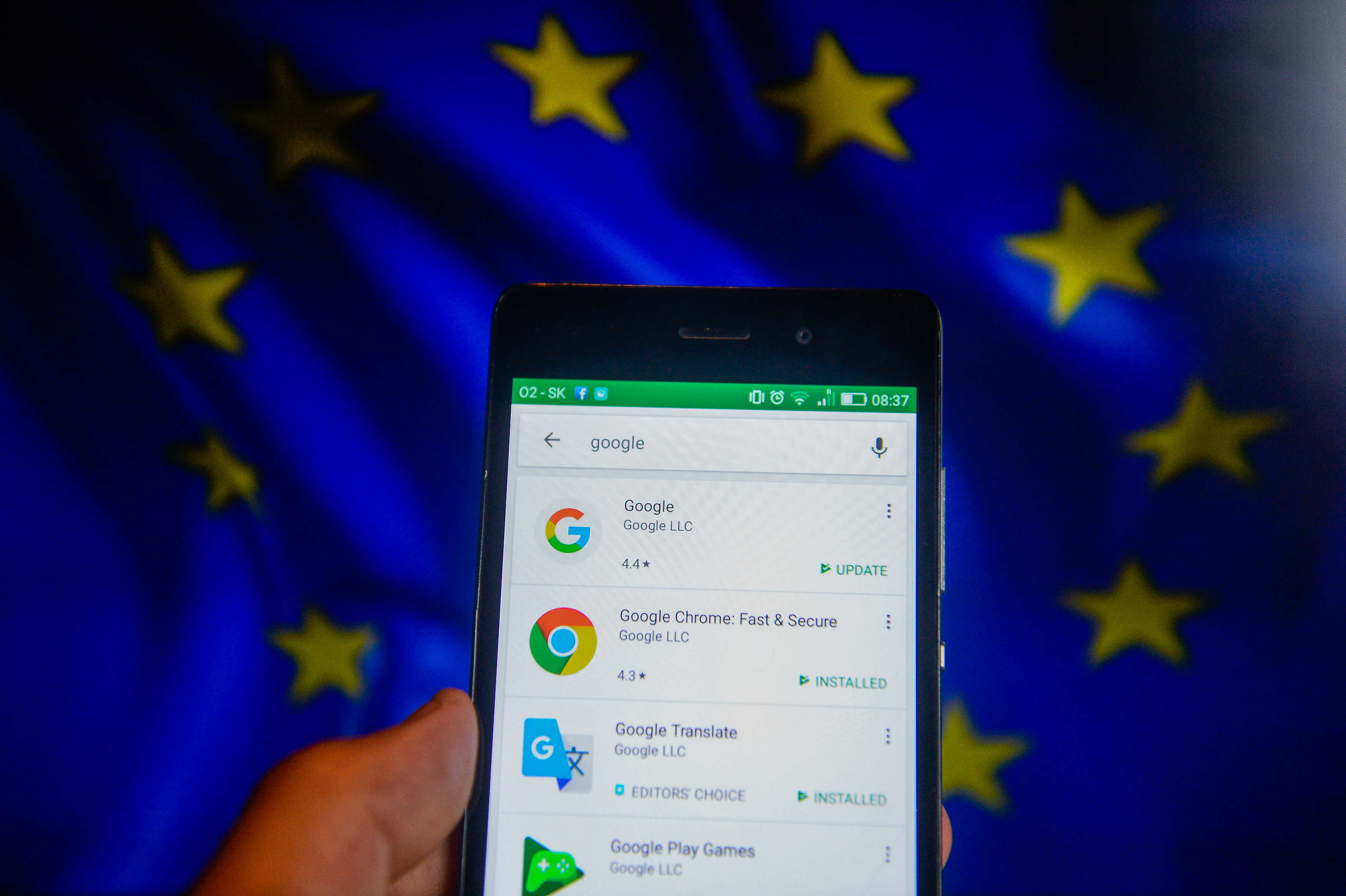 Google apps seen with EU flag on the background