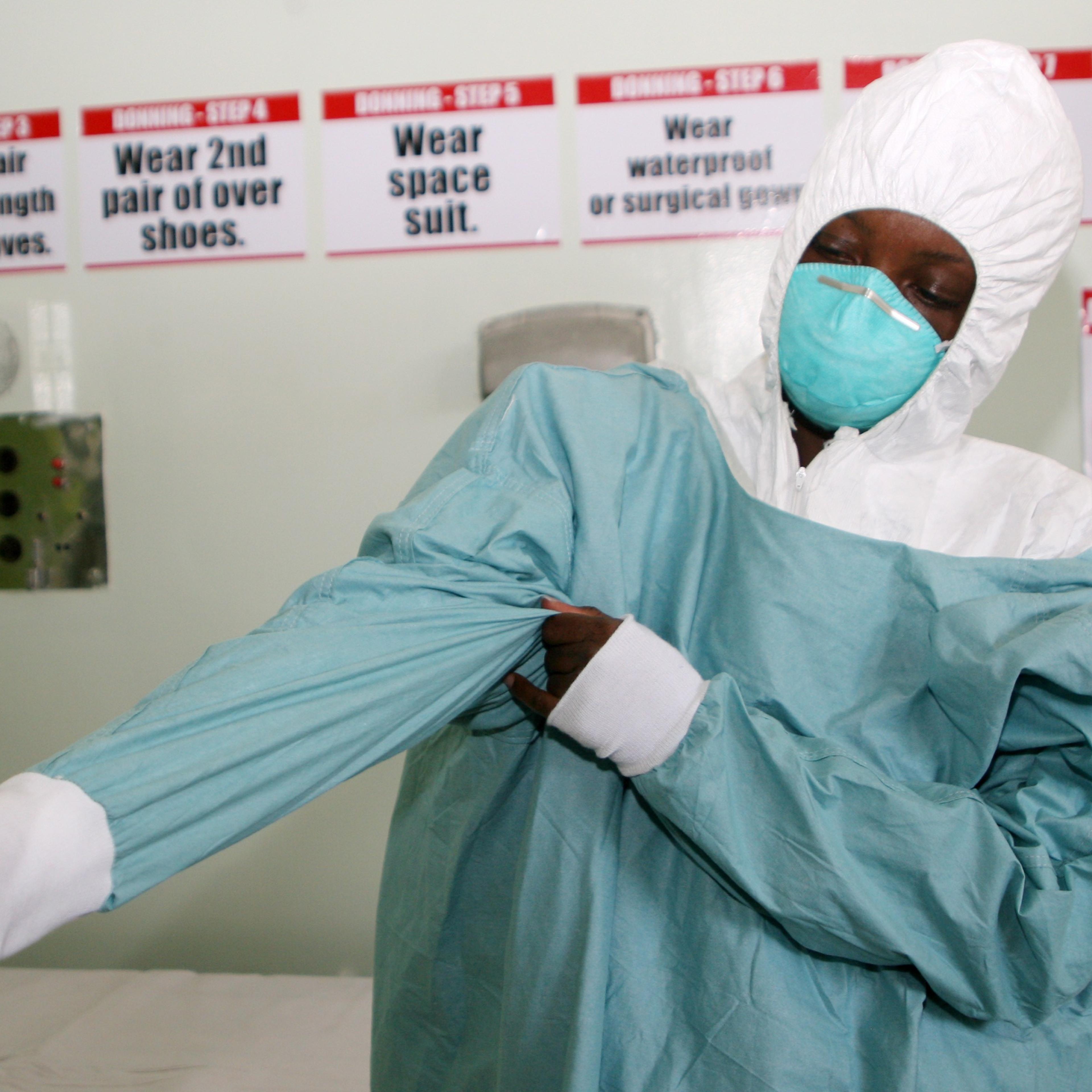 A nurse puts on protective gear during a demonstration at a quarantine unit set up at Wilkins Infectious Diseases Hospital in Harare on Sept. 26, 2014 to deal with ebola virus cases in the event of any outbreak.