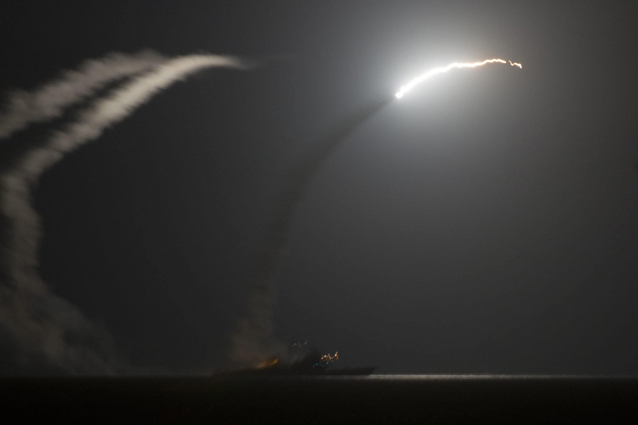 The guided-missile cruiser USS Philippine Sea (CG 58) launches a Tomahawk cruise missile against IS (Islamic State) targets in Syria, as seen from the aircraft carrier USS George H.W. Bush (CVN 77) in the Arabian Gulf, on Sept. 23, 2014.
