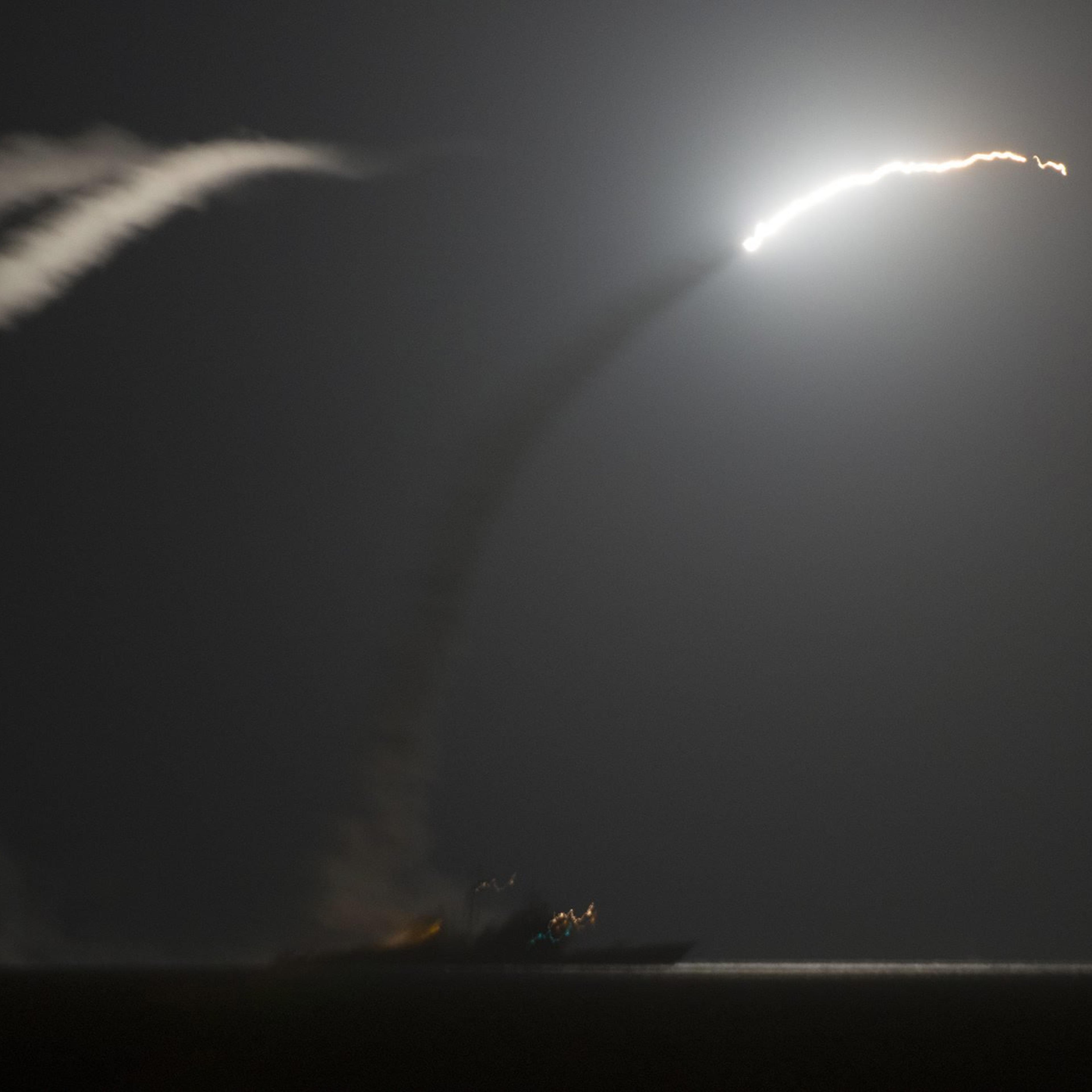 The guided-missile cruiser USS Philippine Sea (CG 58) launches a Tomahawk cruise missile against IS (Islamic State) targets in Syria, as seen from the aircraft carrier USS George H.W. Bush (CVN 77) in the Arabian Gulf, on Sept. 23, 2014.