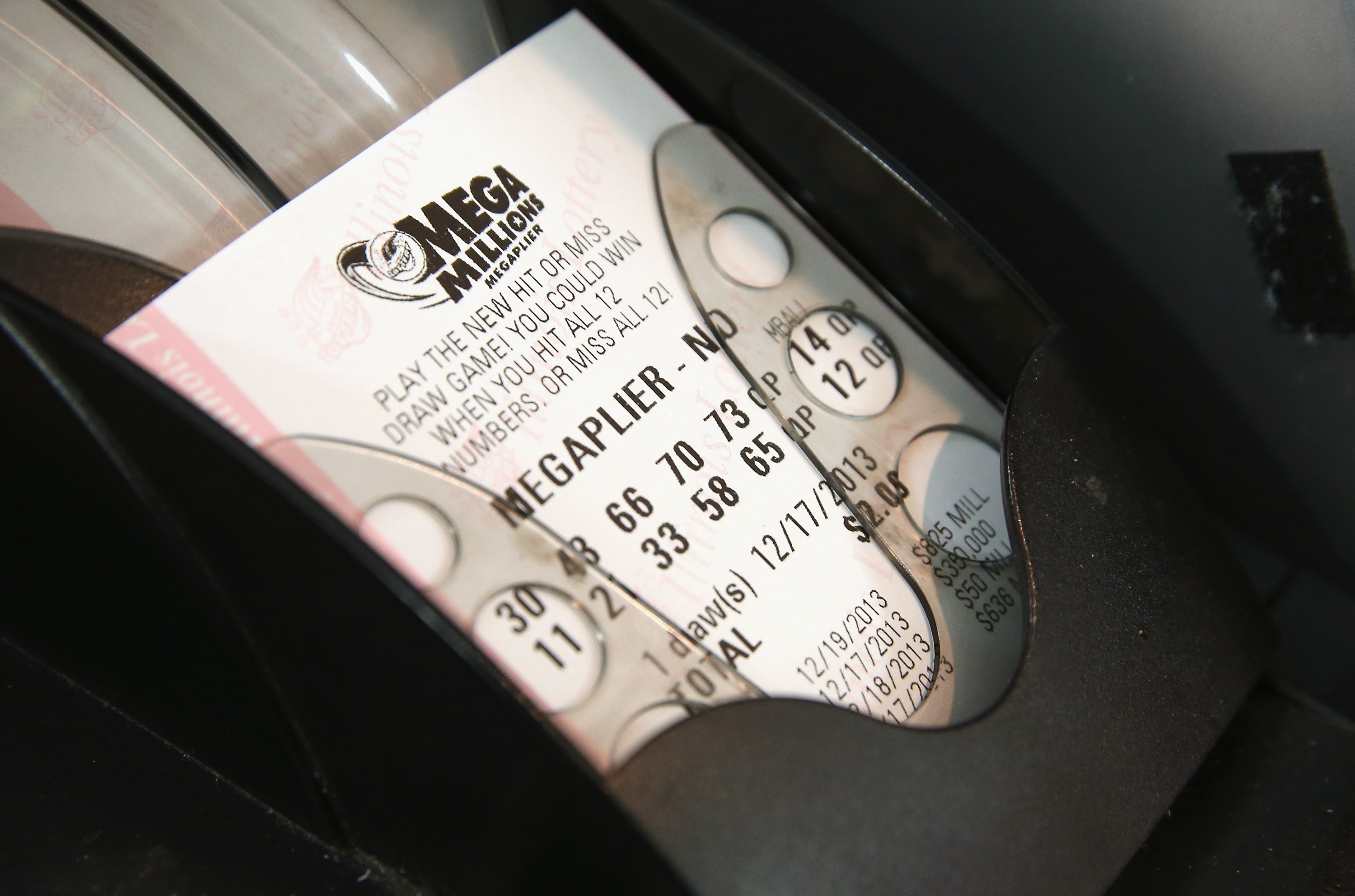 A machine prints a Mega Millions lottery ticket for a customer at a convenience store in Chicago on Dec.17, 2013.