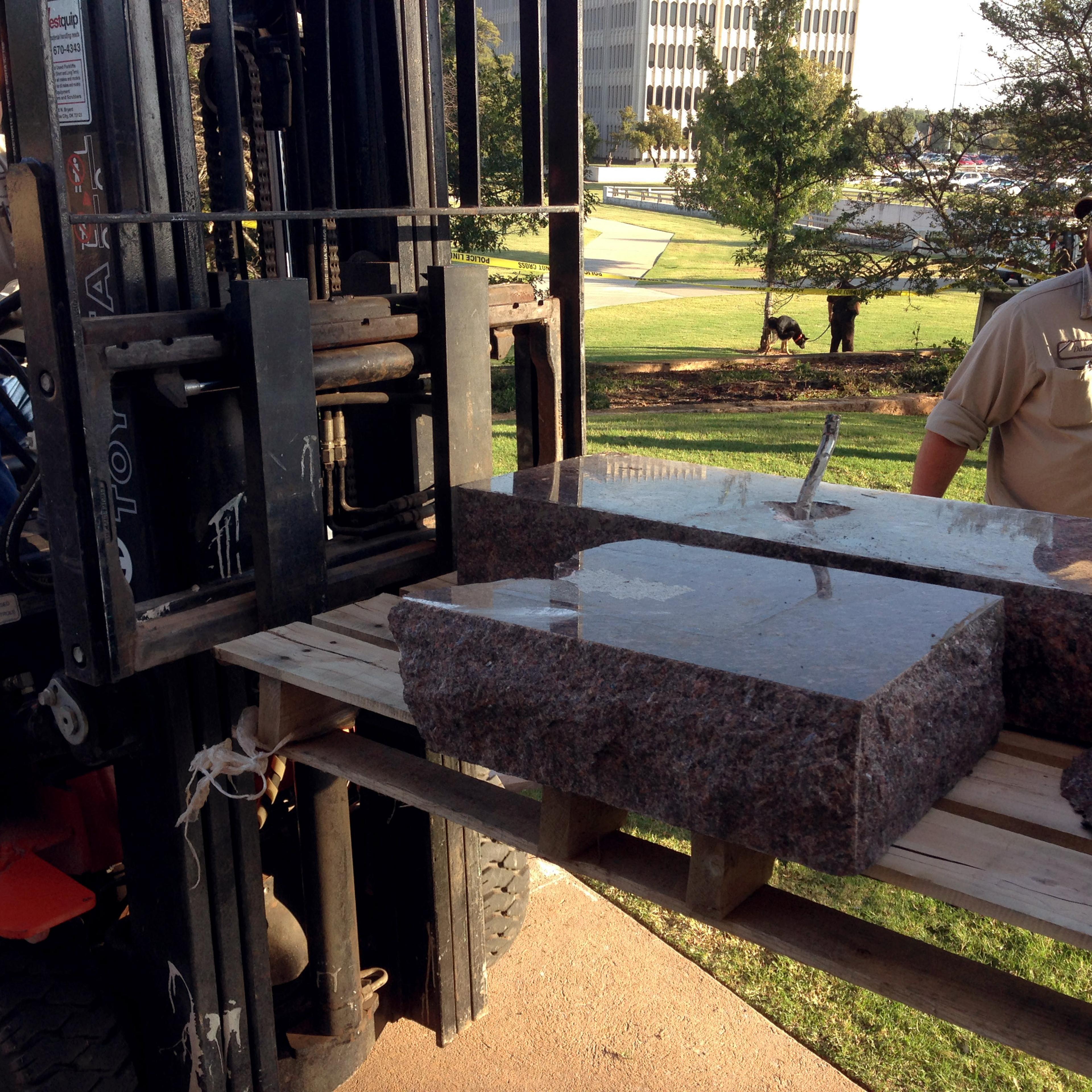 State workers for the Office of Management and Enterprise Services remove the damaged remains of a Ten Commandments monument from the Oklahoma State Capitol grounds on Oct. 24, 2014 in Oklahoma City.