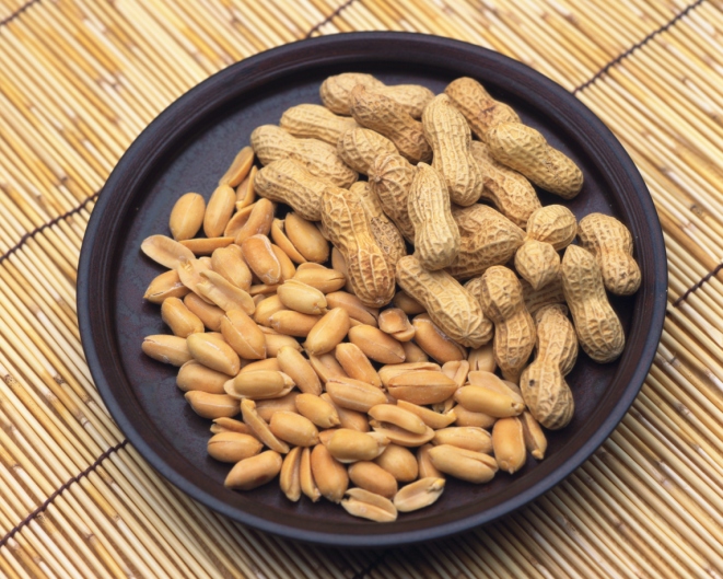 Closed Up Image of a Black-colored Plate Filled With Peanuts.