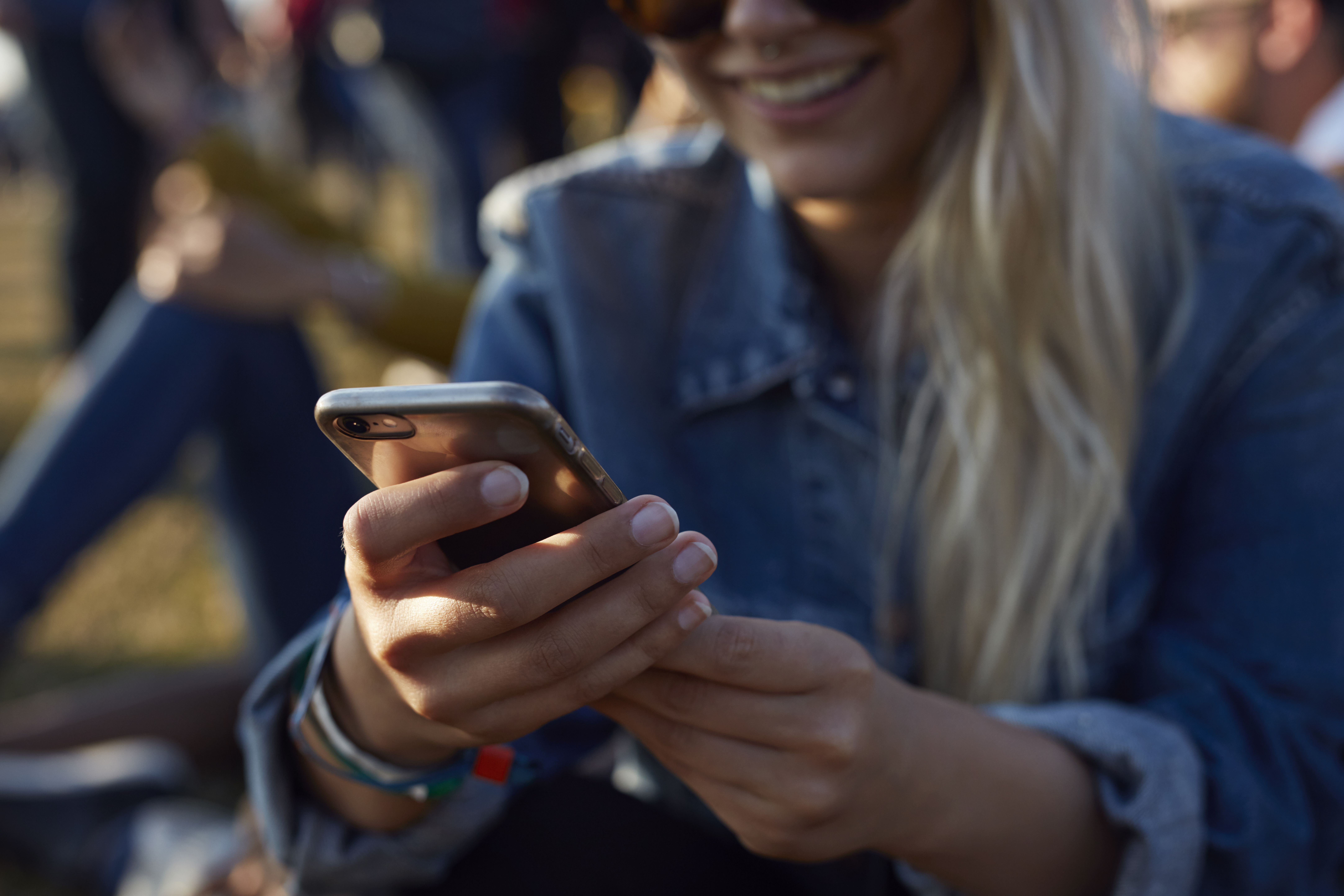 Woman checking phone at festival