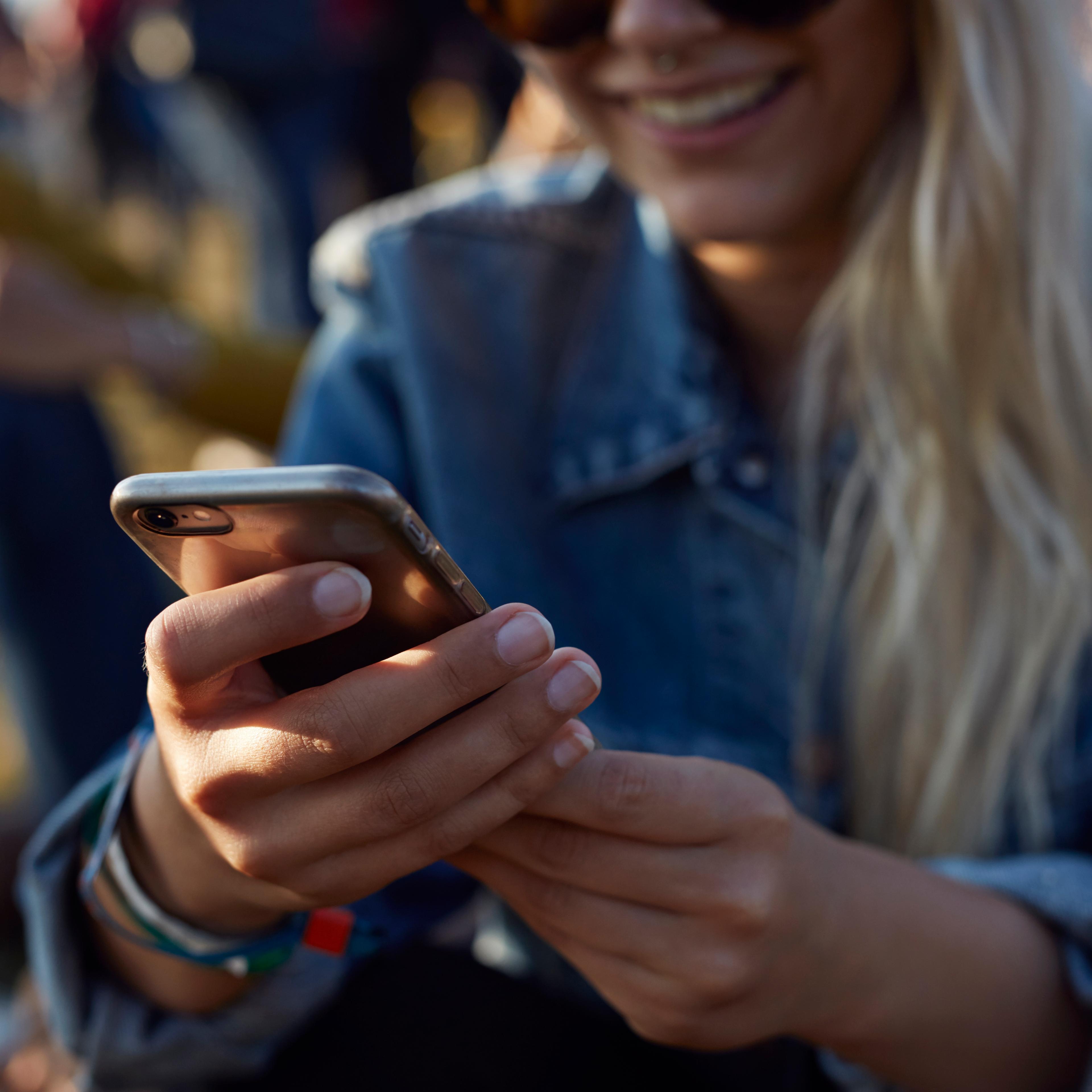 Woman checking phone at festival