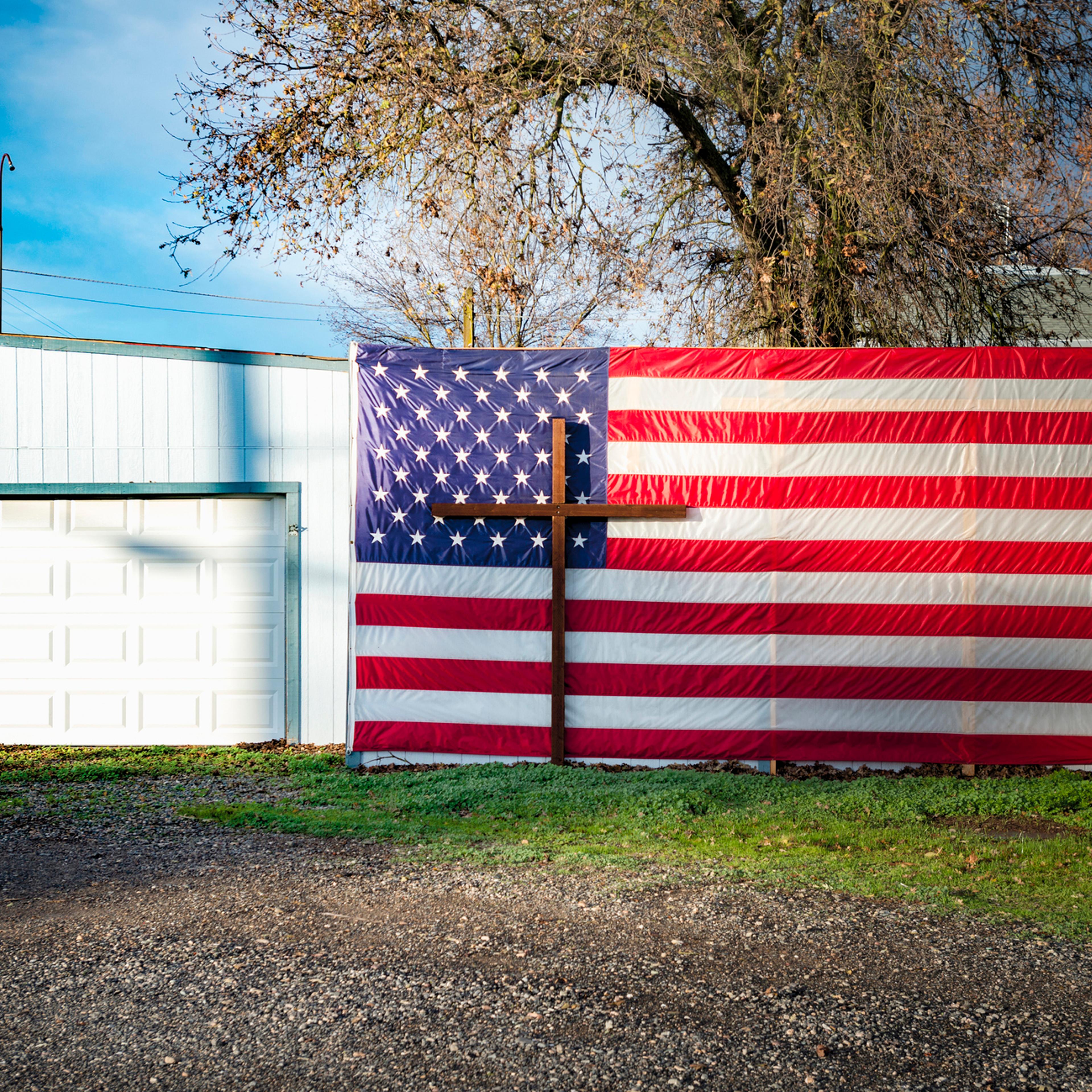 Crucifix and American flag at garage