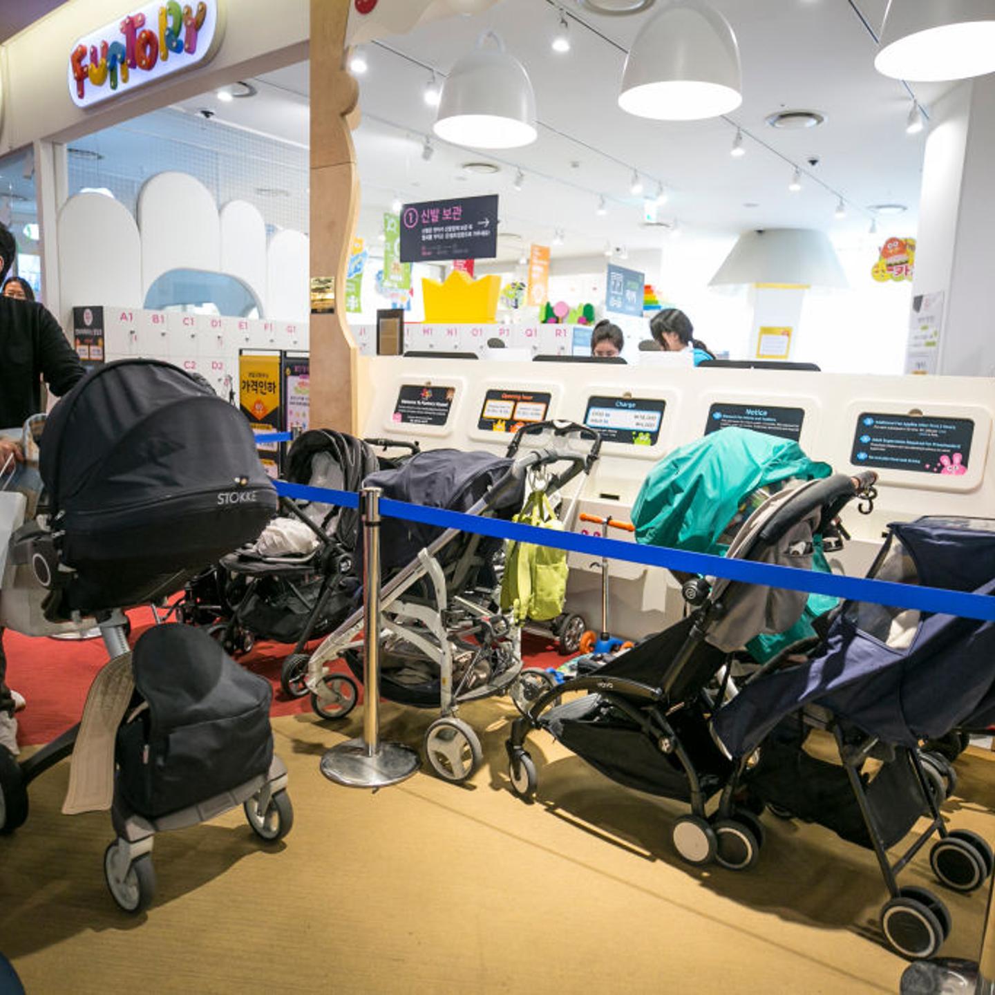 Baby strollers are parked outside a kids cafe inside a shopping mall on March 9, 2019 in Seoul, South Korea.