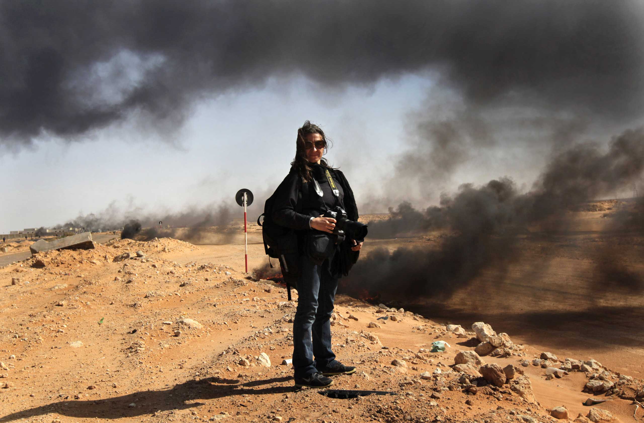 Photographer Lynsey Addario stands near the frontline