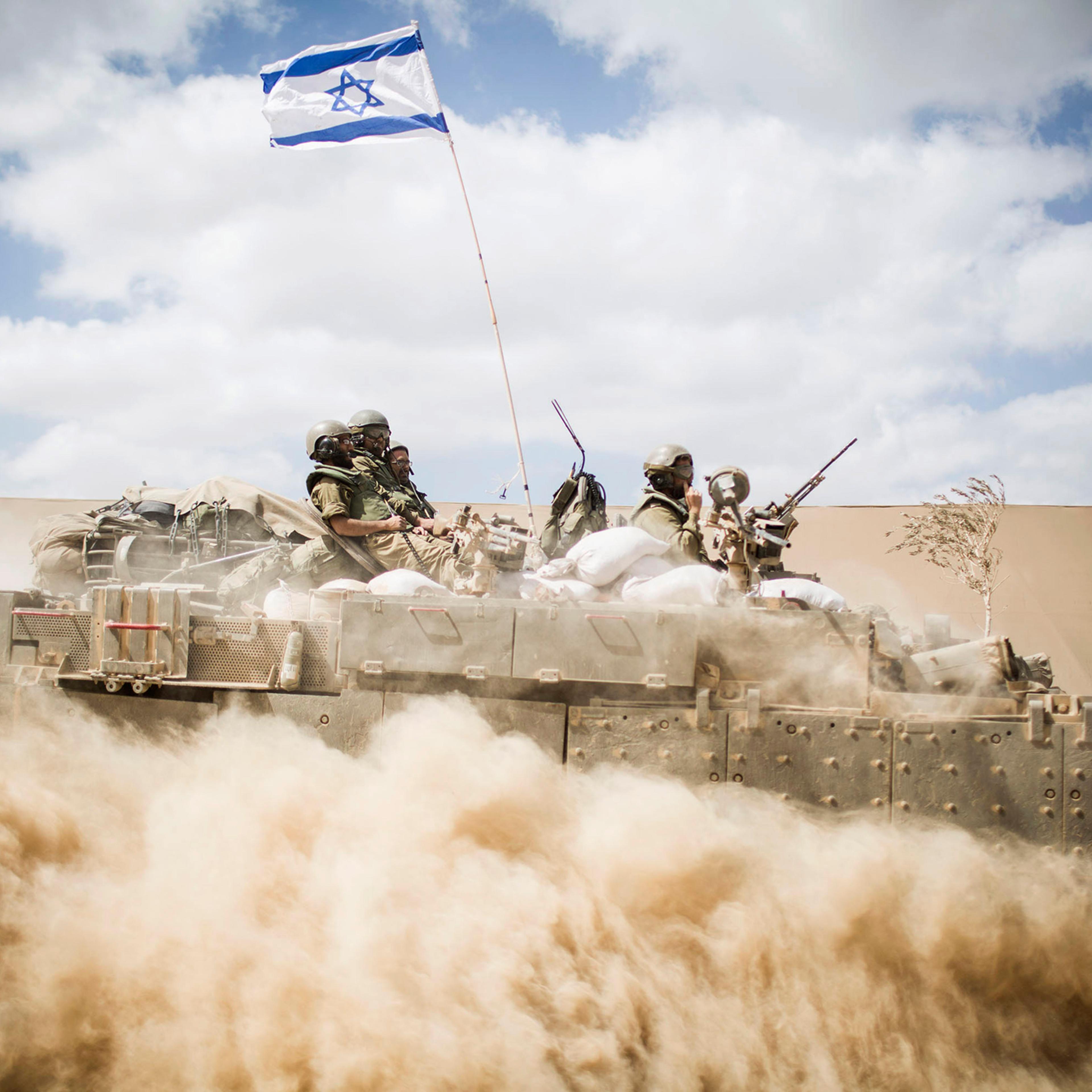 An Israeli armed vehicle seen passing near the Israeli-Gaza border on July 25, 2014 near Israel's border with the Gaza Strip.