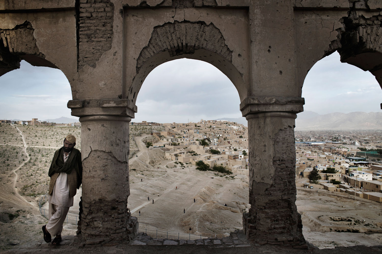 The tomb of Sultan Mohammed Telai, great-great grandfather of Nadir Shir, an Afghan king. Its arches are decorated in Italianate stucco, but the tomb itself is badly damaged and graffitied. The strategic location of the hill is readily apparent from here, and was much fought over in the 1990s.