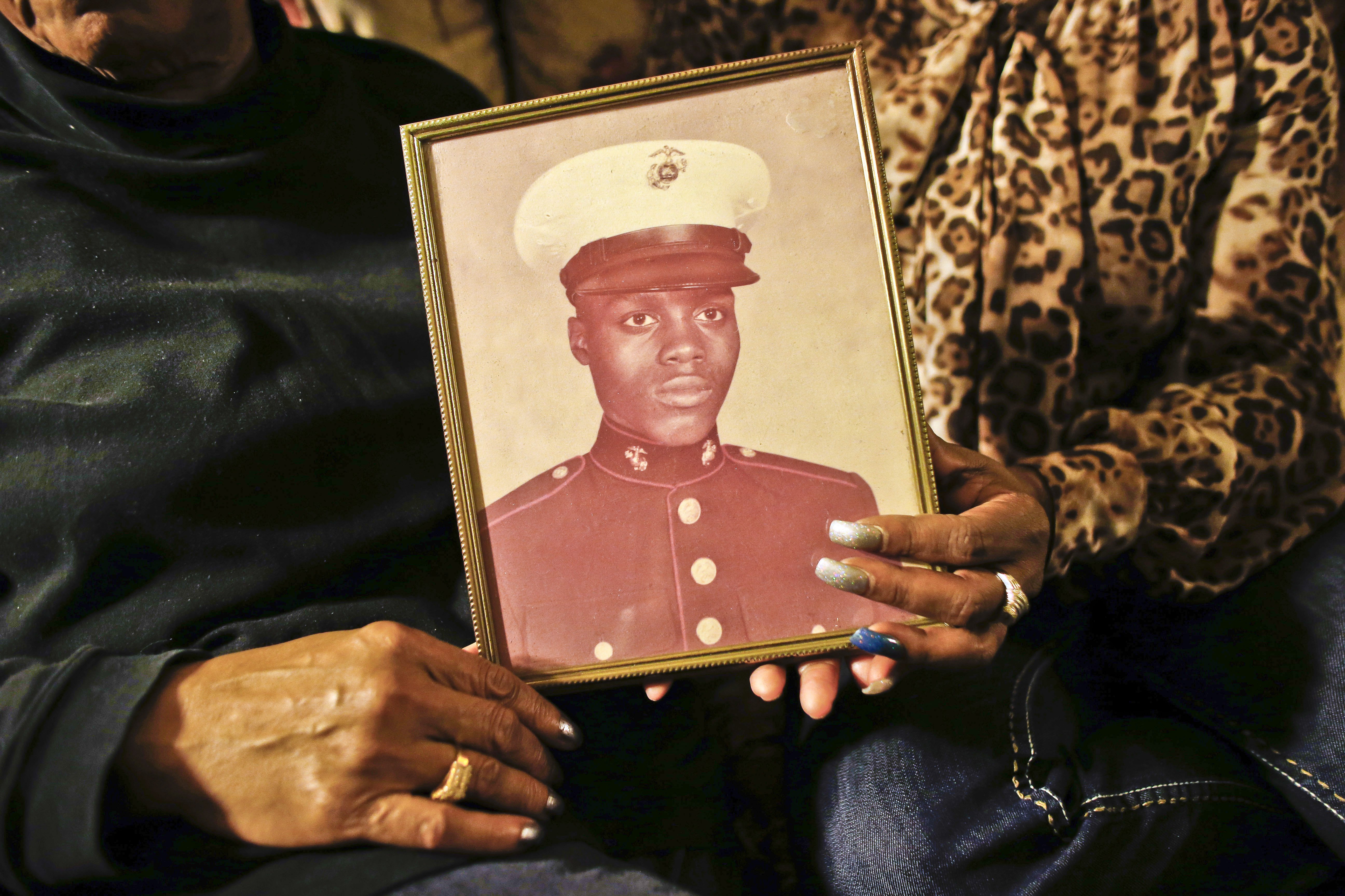 A picture of Jerome Murdough, a former homeless Marine who died in a mental observation unit on Rikers Island jail on Feb. 15, 2014 is held by his mother Alma Murdough left, and sister Cheryl Warner at Alma Murdough's home in the Queens borough of New Yo