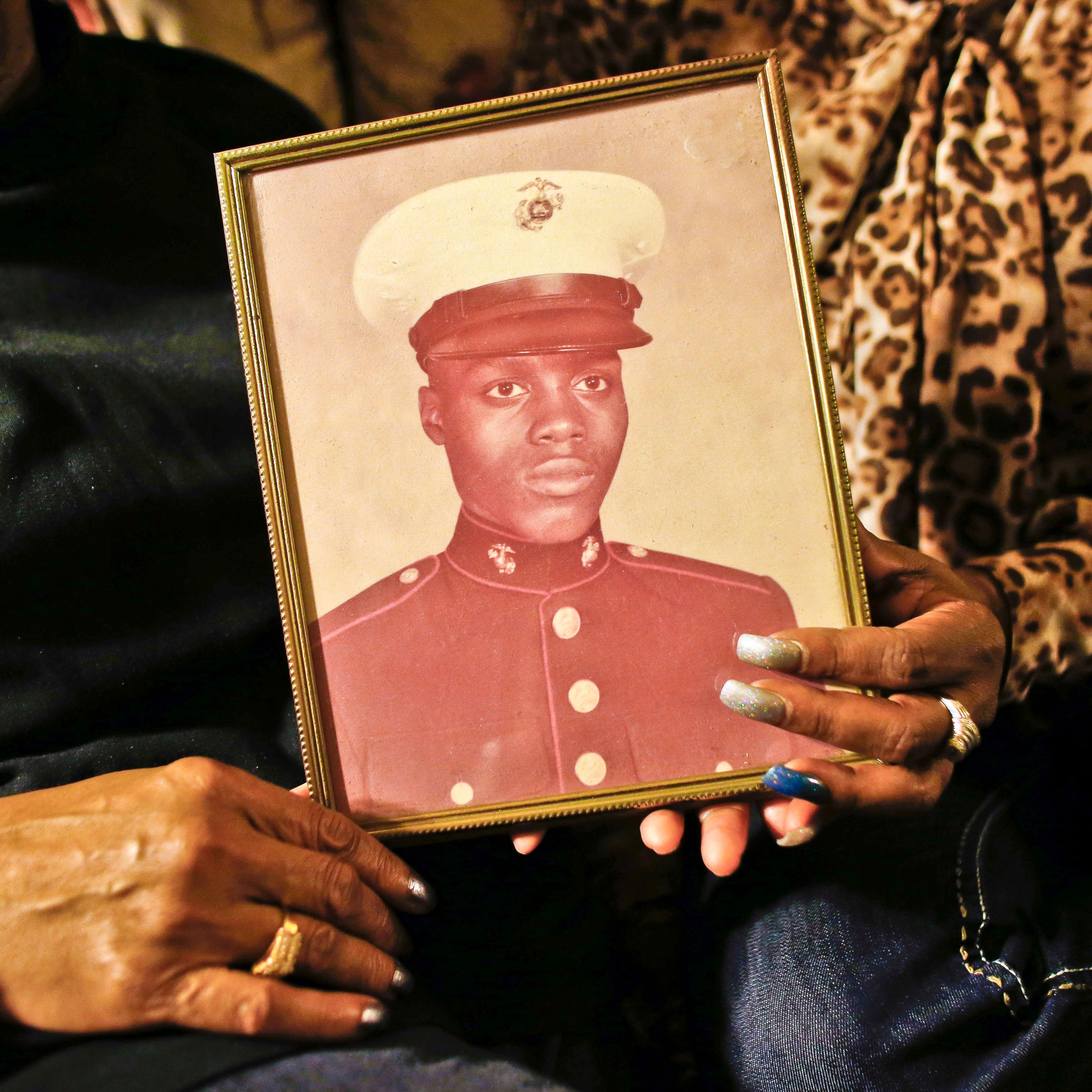 A picture of Jerome Murdough, a former homeless Marine who died in a mental observation unit on Rikers Island jail on Feb. 15, 2014 is held by his mother Alma Murdough left, and sister Cheryl Warner at Alma Murdough's home in the Queens borough of New Yo