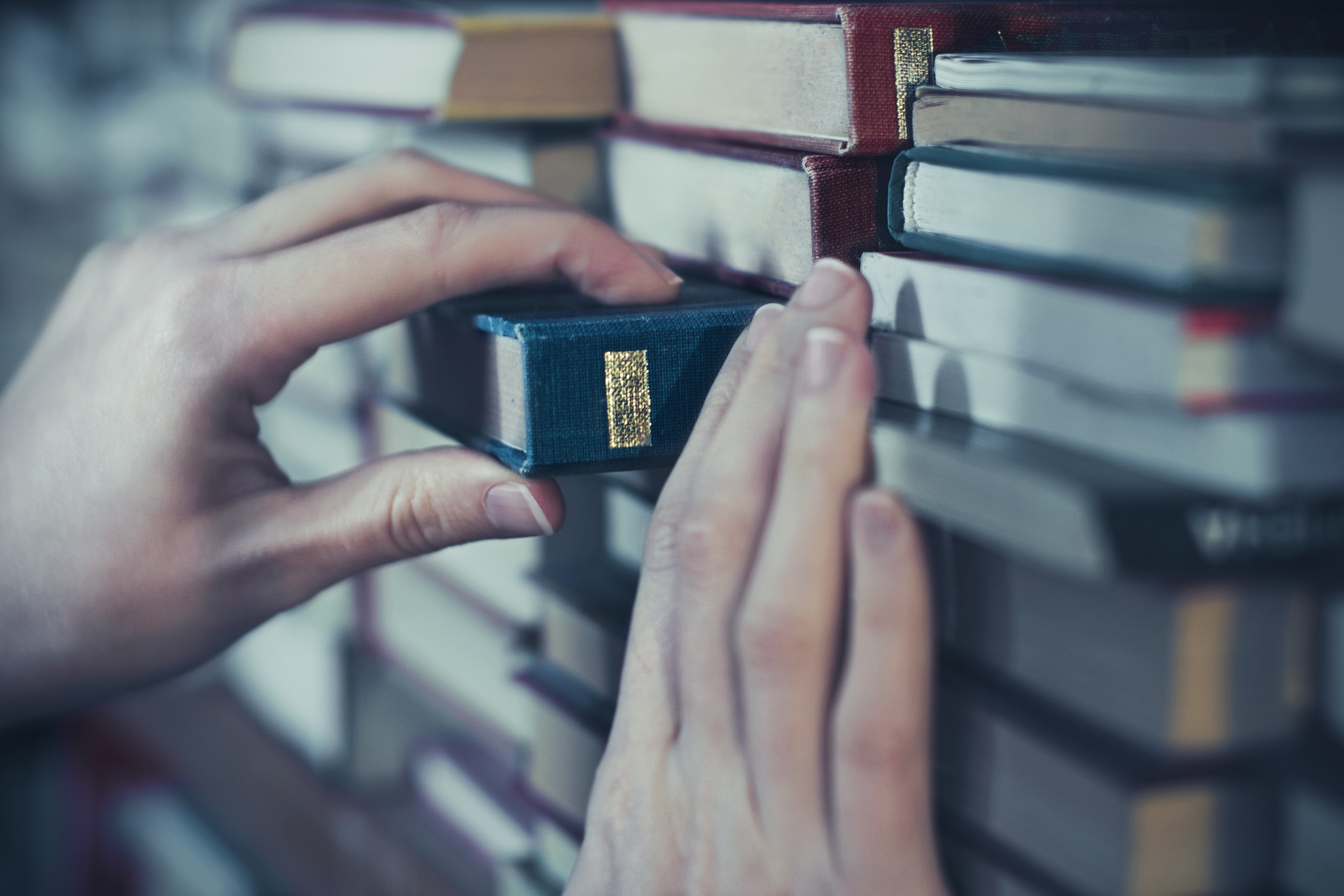 Woman reaching book from shelf