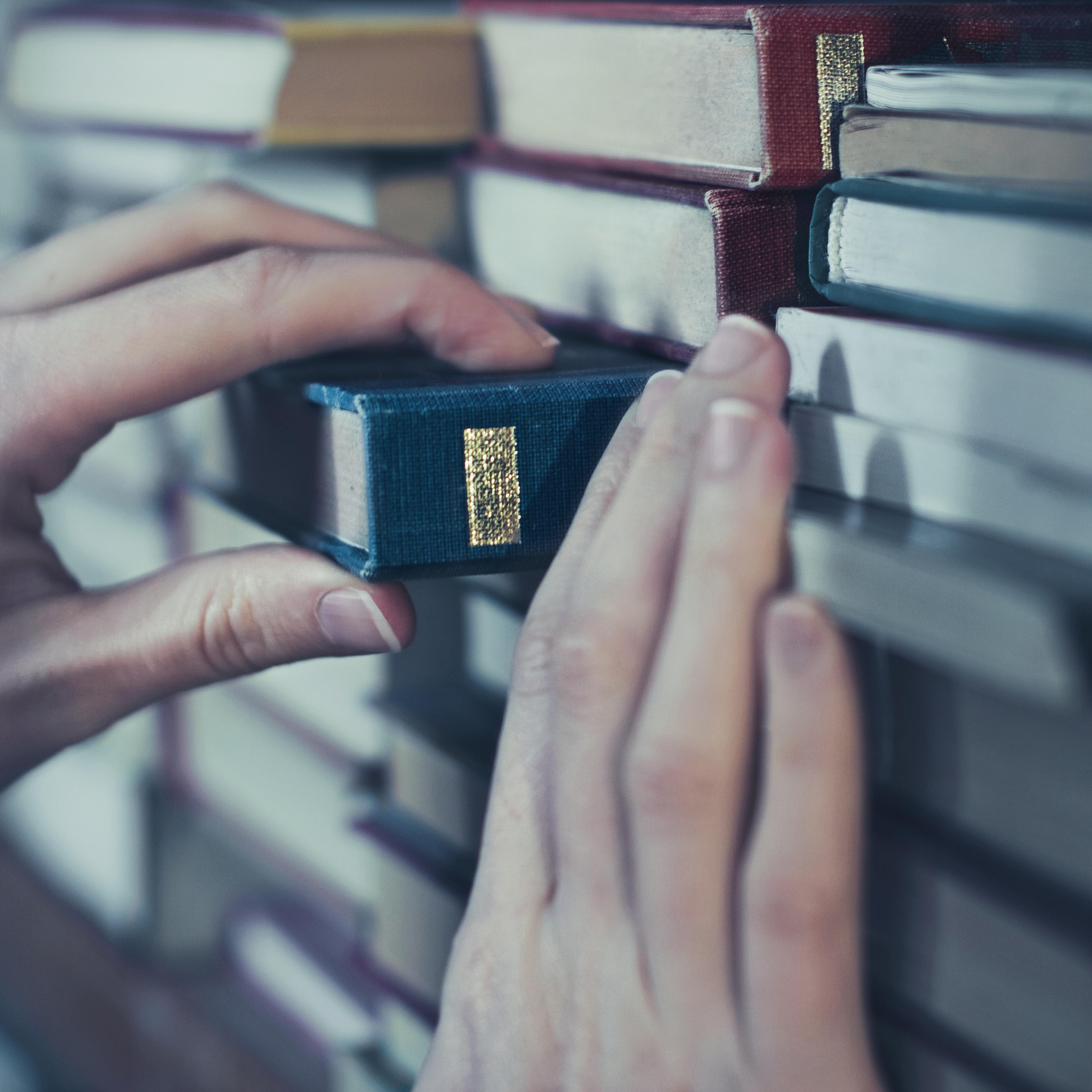 Woman reaching book from shelf