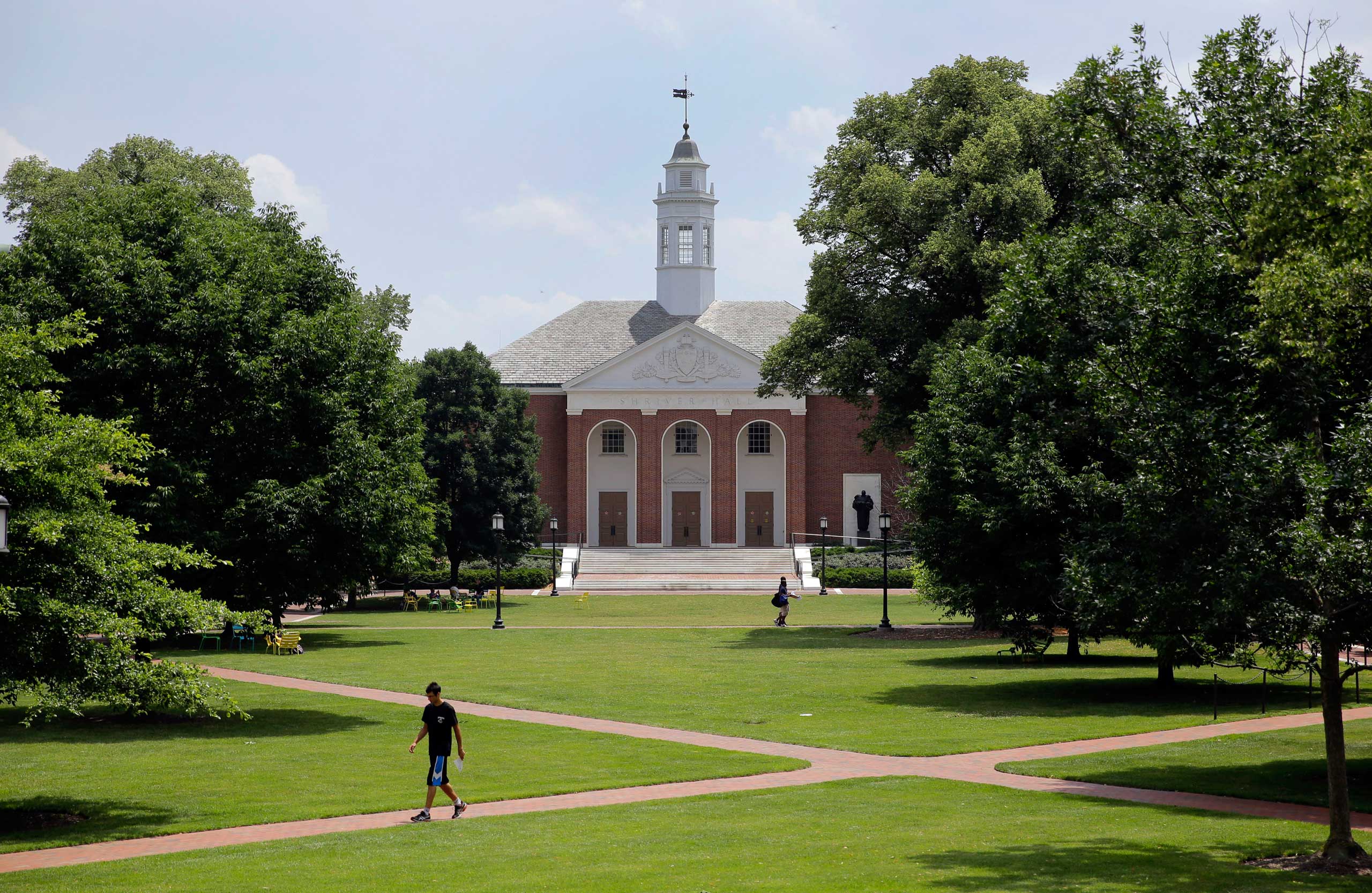 People walk on Johns Hopkins University's Homewood campus in Baltimore on July 8, 2014.