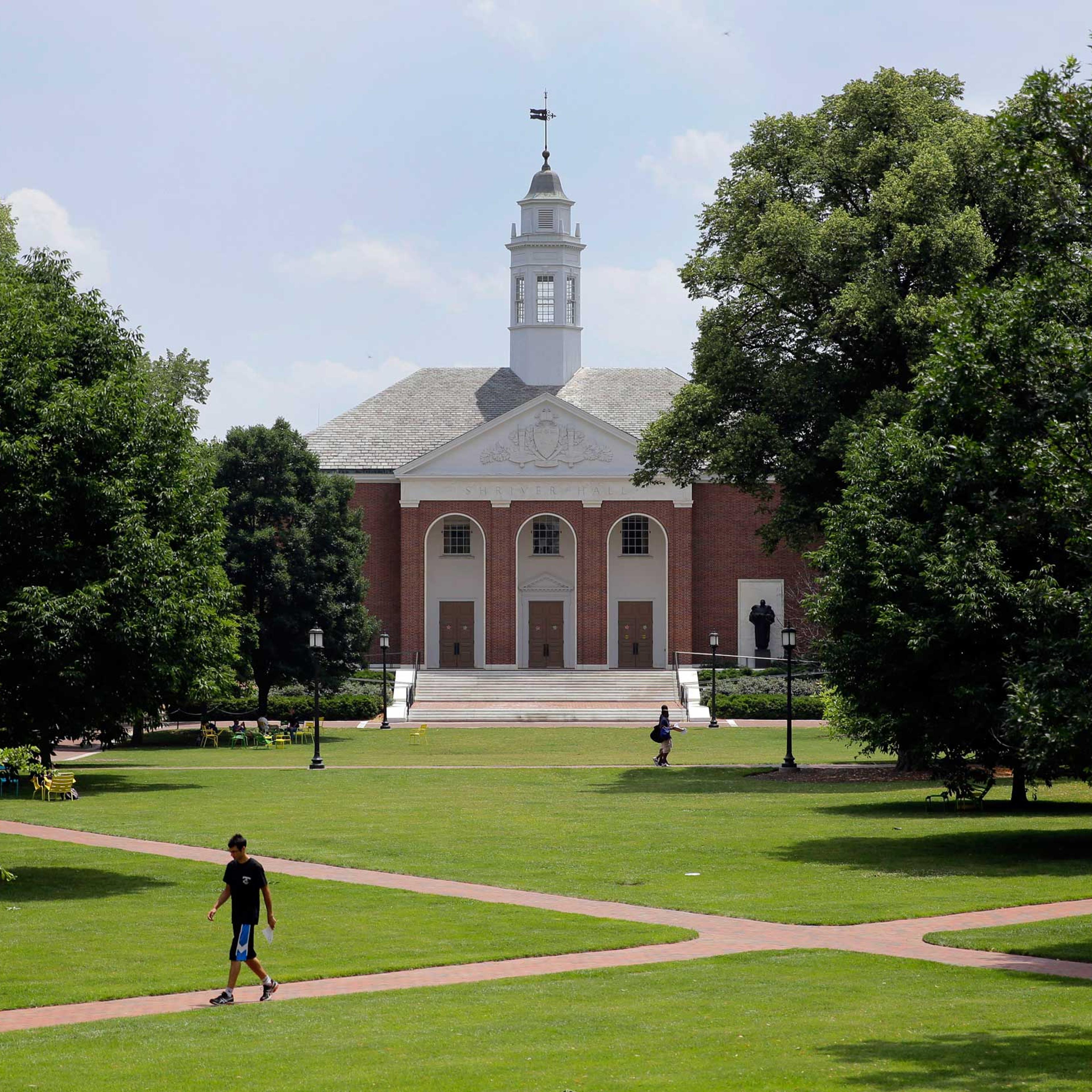 People walk on Johns Hopkins University's Homewood campus in Baltimore on July 8, 2014.
