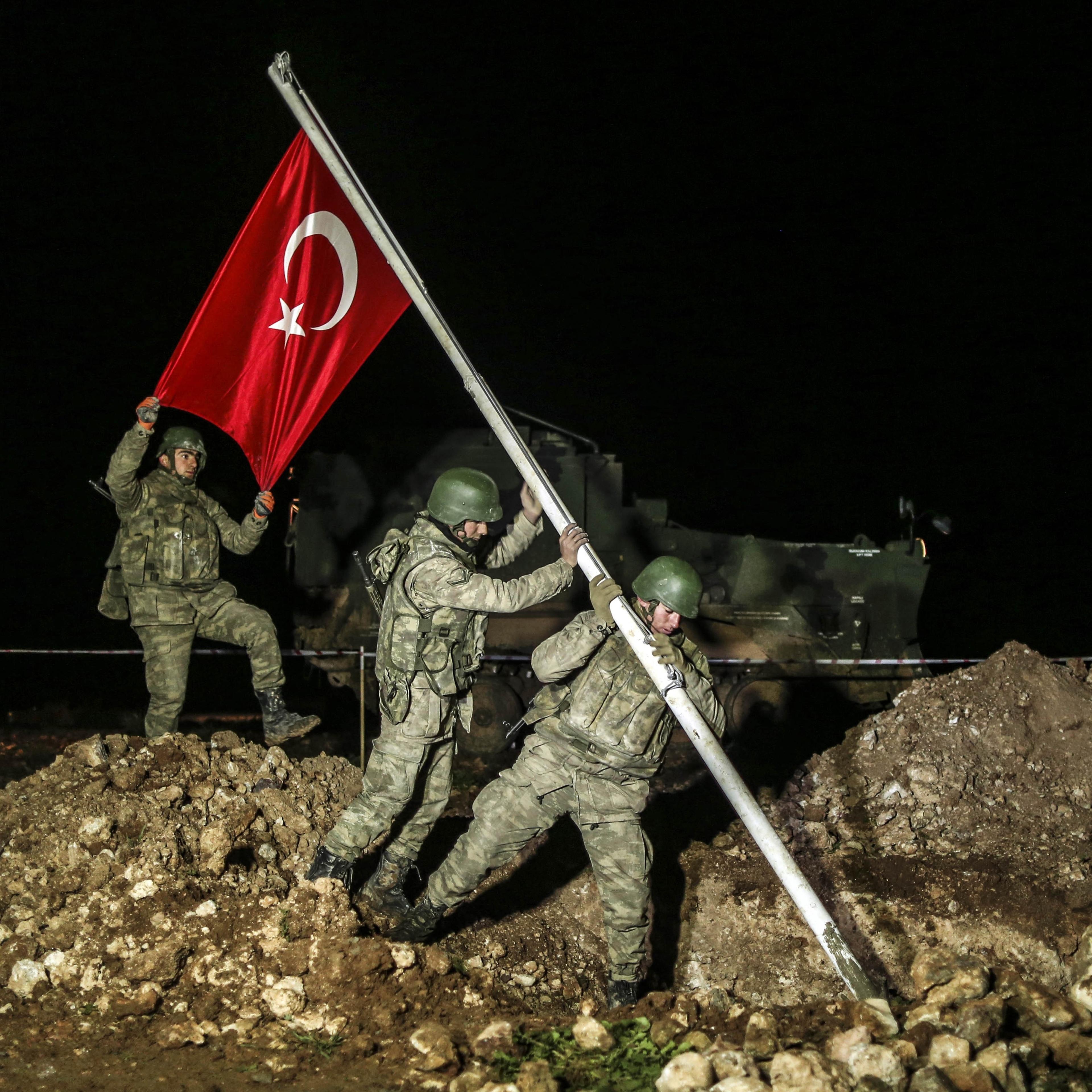 Turkish soldiers put a wire fence around area after Turkish flag is raised on Feb. 22, 2015 in the Esme region of Aleppo where the Tomb of Suleyman Shah will be placed.