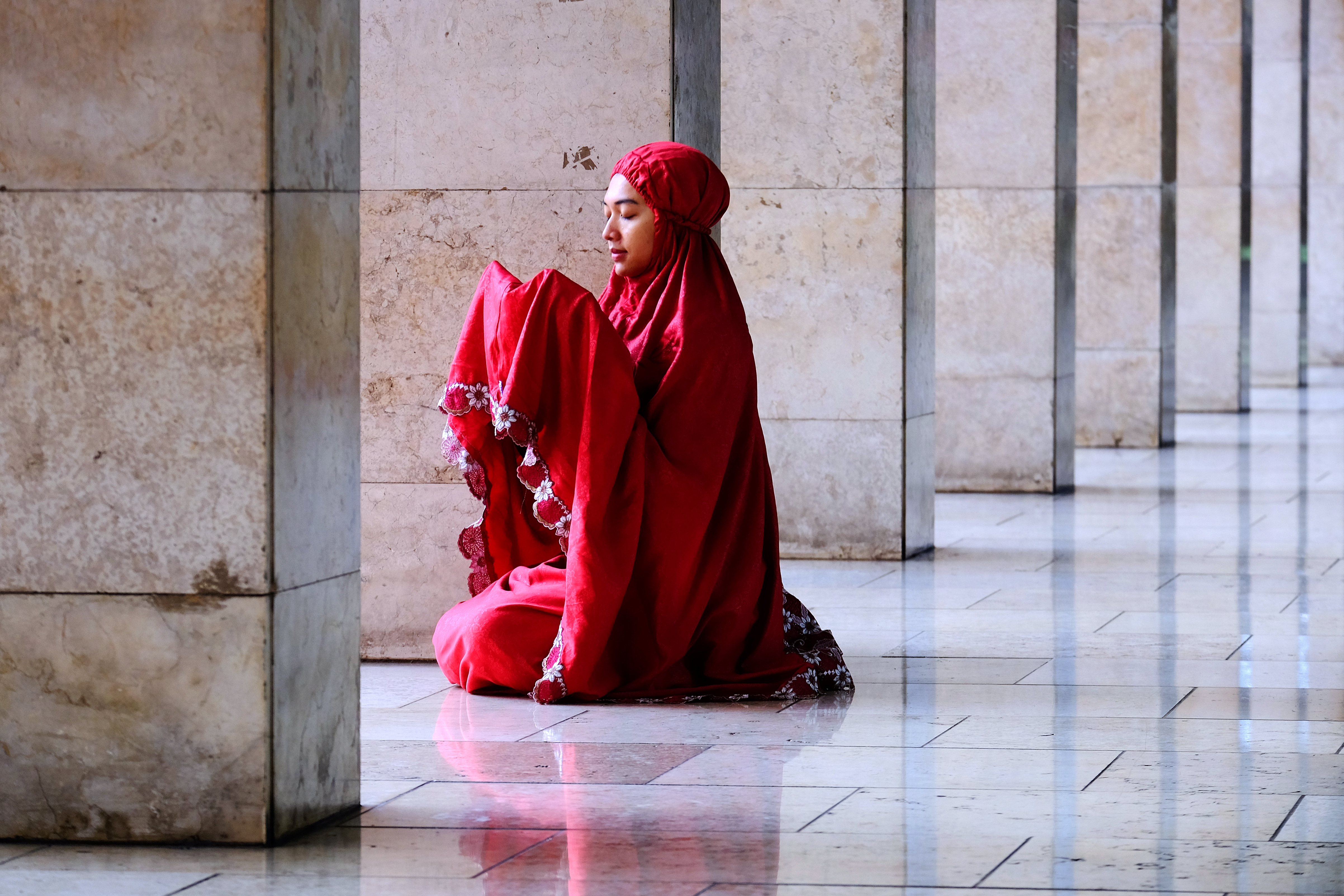 Woman praying in Istiqlal Mosque. Jakarta, Indonesia.