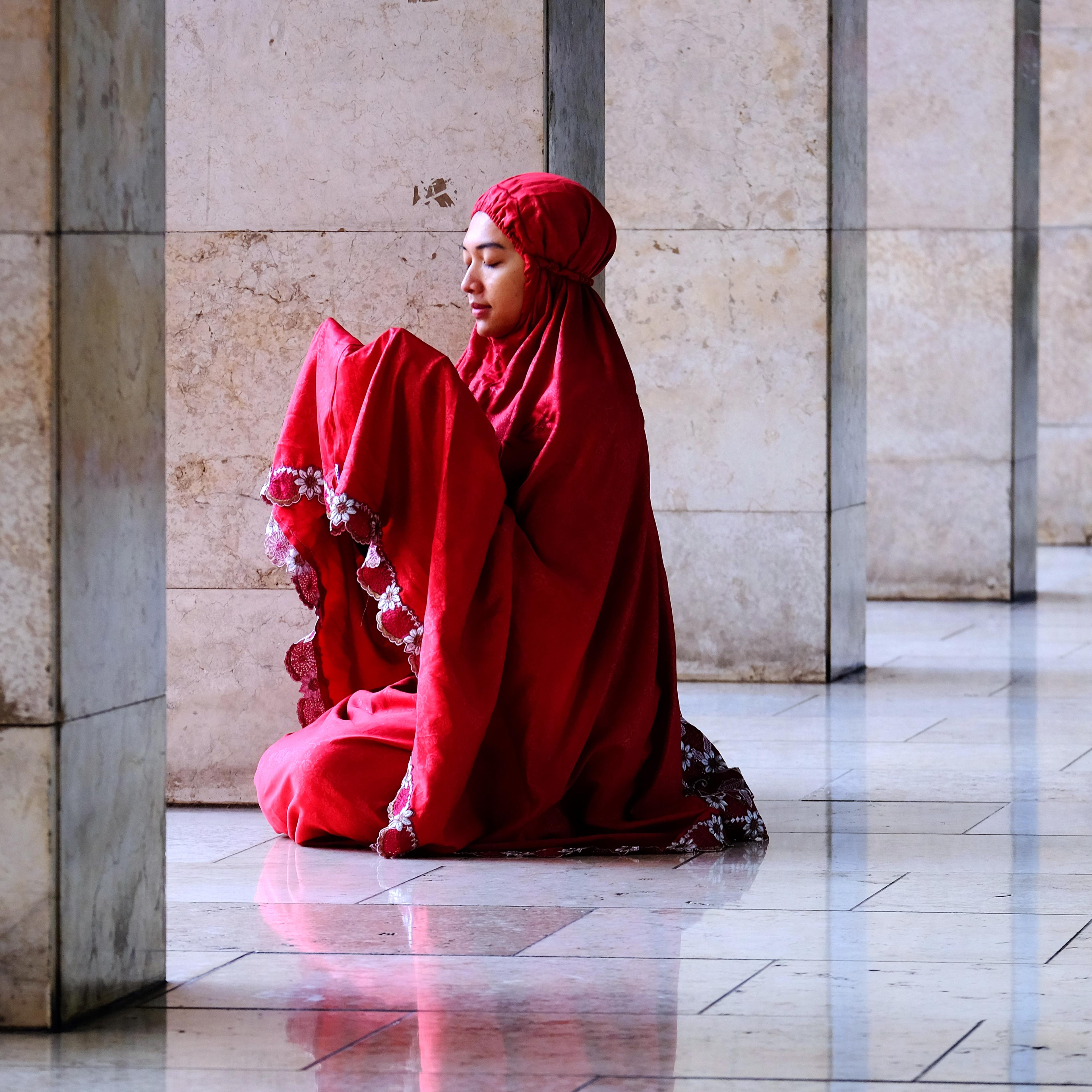 Woman praying in Istiqlal Mosque. Jakarta, Indonesia.