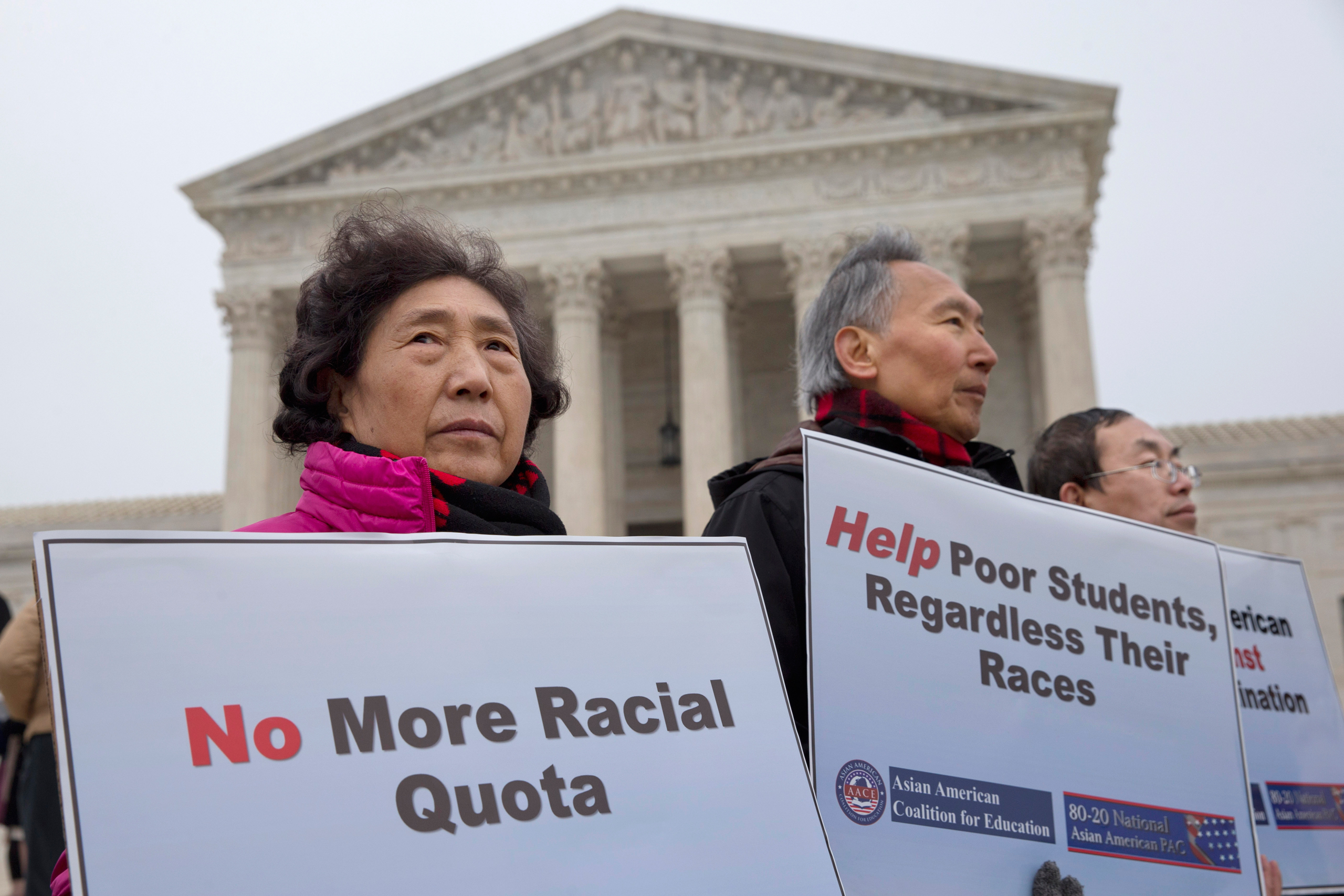Guixue Zhou of North Potomac, Md., left, and others, protests against racial quotas outside the Supreme Court in Washington, Wednesday, Dec. 9, 2015, as the court hears oral arguments in the Fisher v. University of Texas at Austin affirmative action case