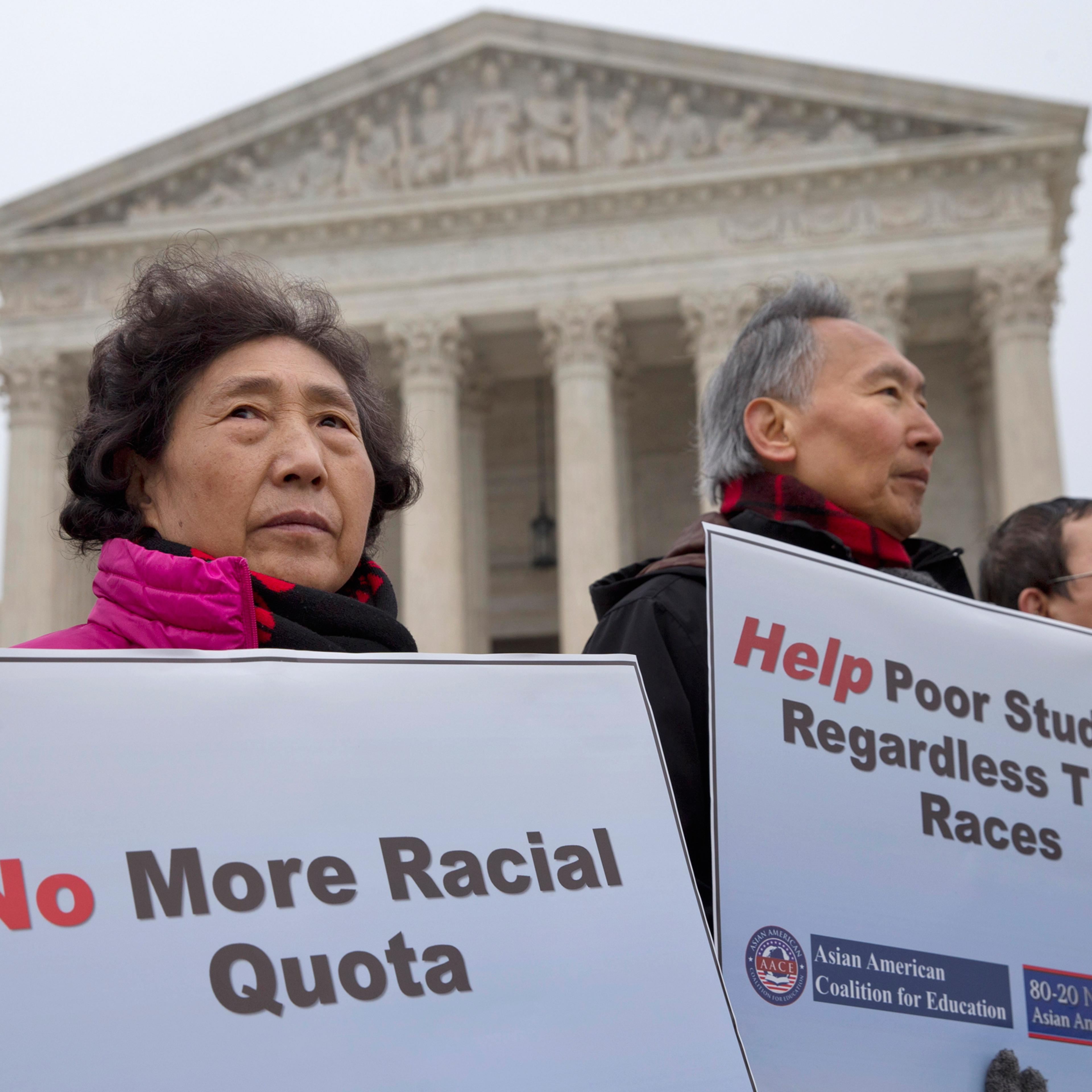 Guixue Zhou of North Potomac, Md., left, and others, protests against racial quotas outside the Supreme Court in Washington, Wednesday, Dec. 9, 2015, as the court hears oral arguments in the Fisher v. University of Texas at Austin affirmative action case