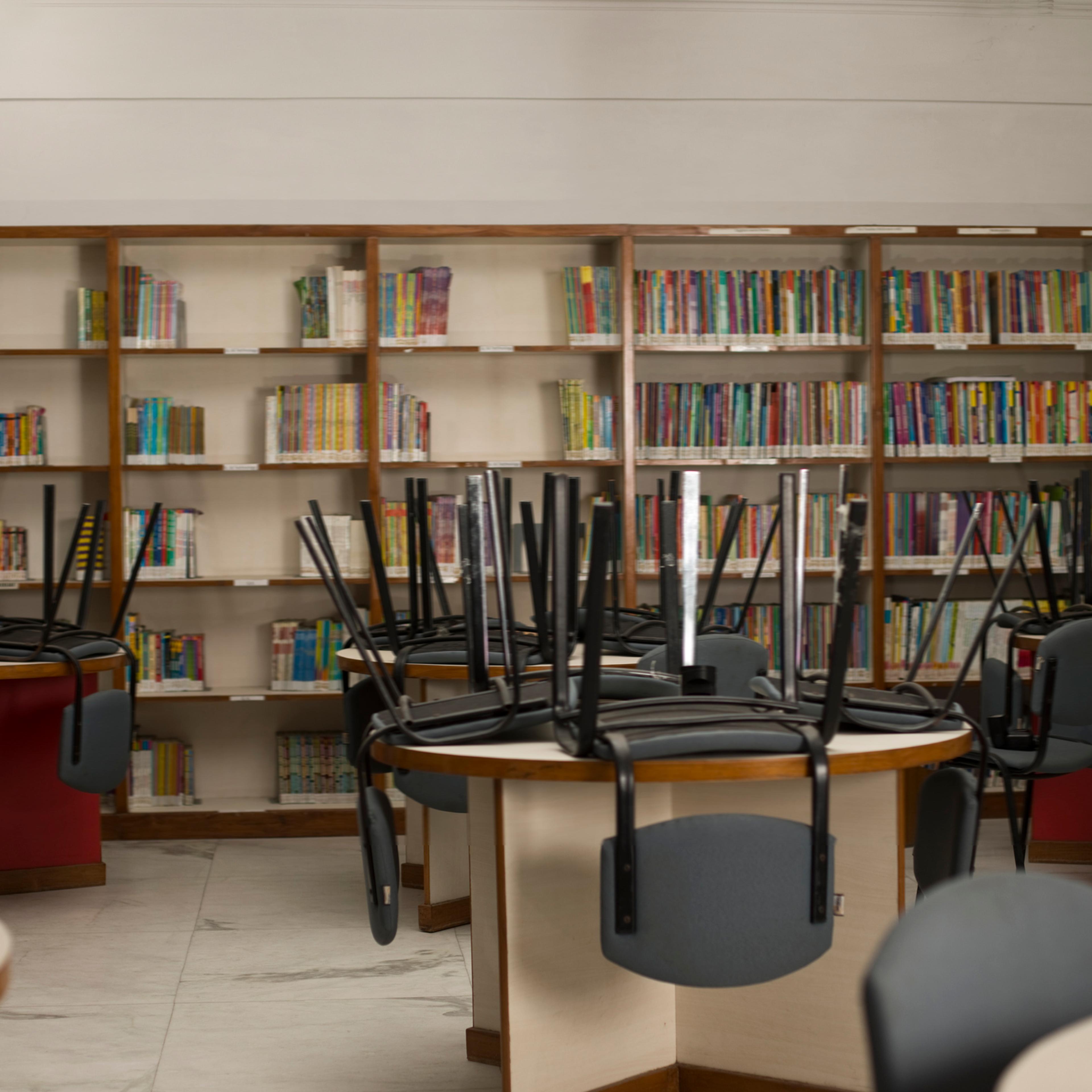 Chairs upside down on tables in public library
