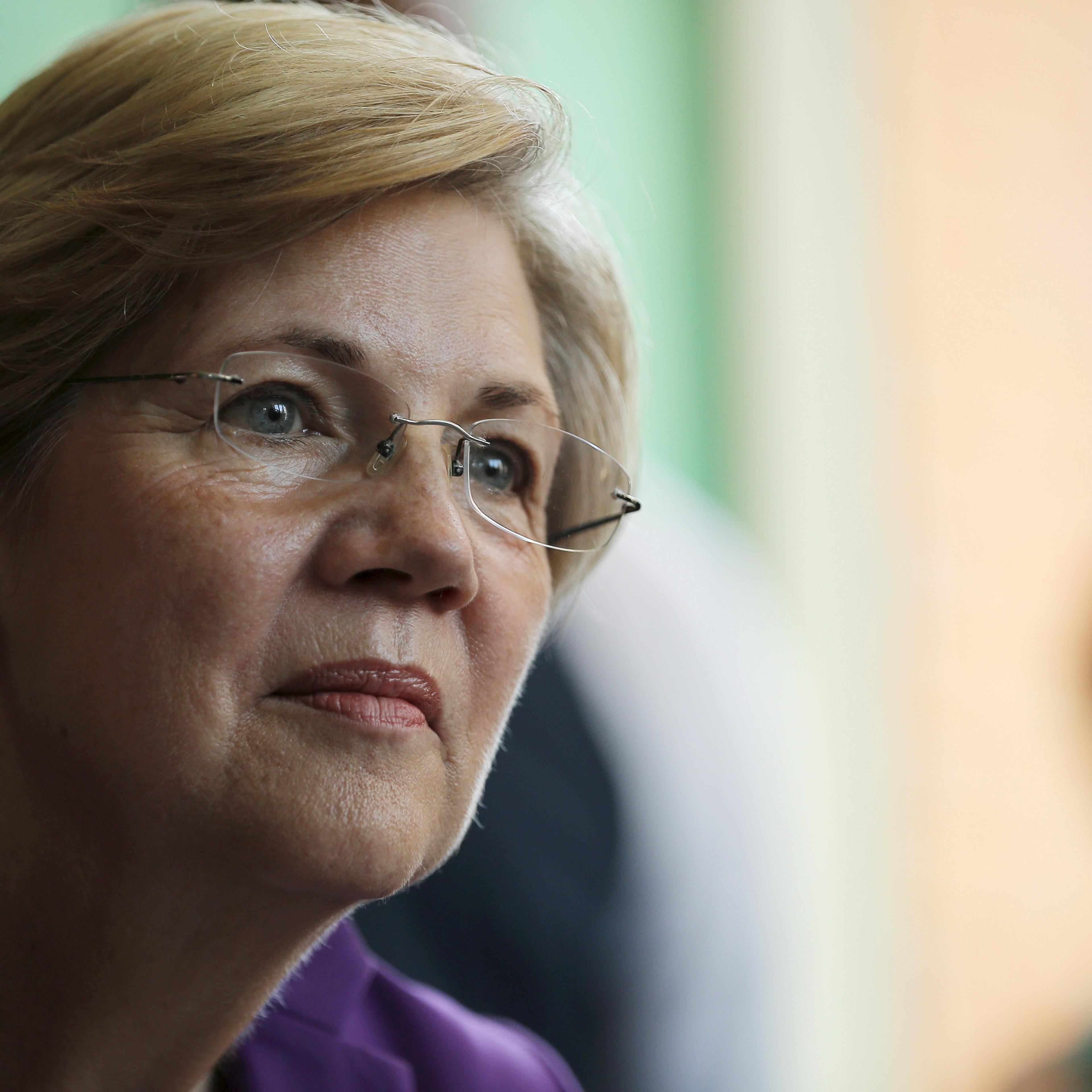 U.S. Senator Elizabeth Warren listens to workers tell their stories about erratic workplace schedules at the Equal Exchange Cafe in Boston